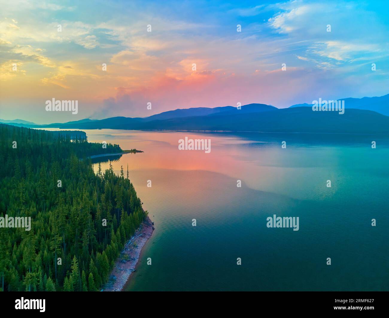 Aerial view of Hungry Horse Reservoir with forest fire in the distance