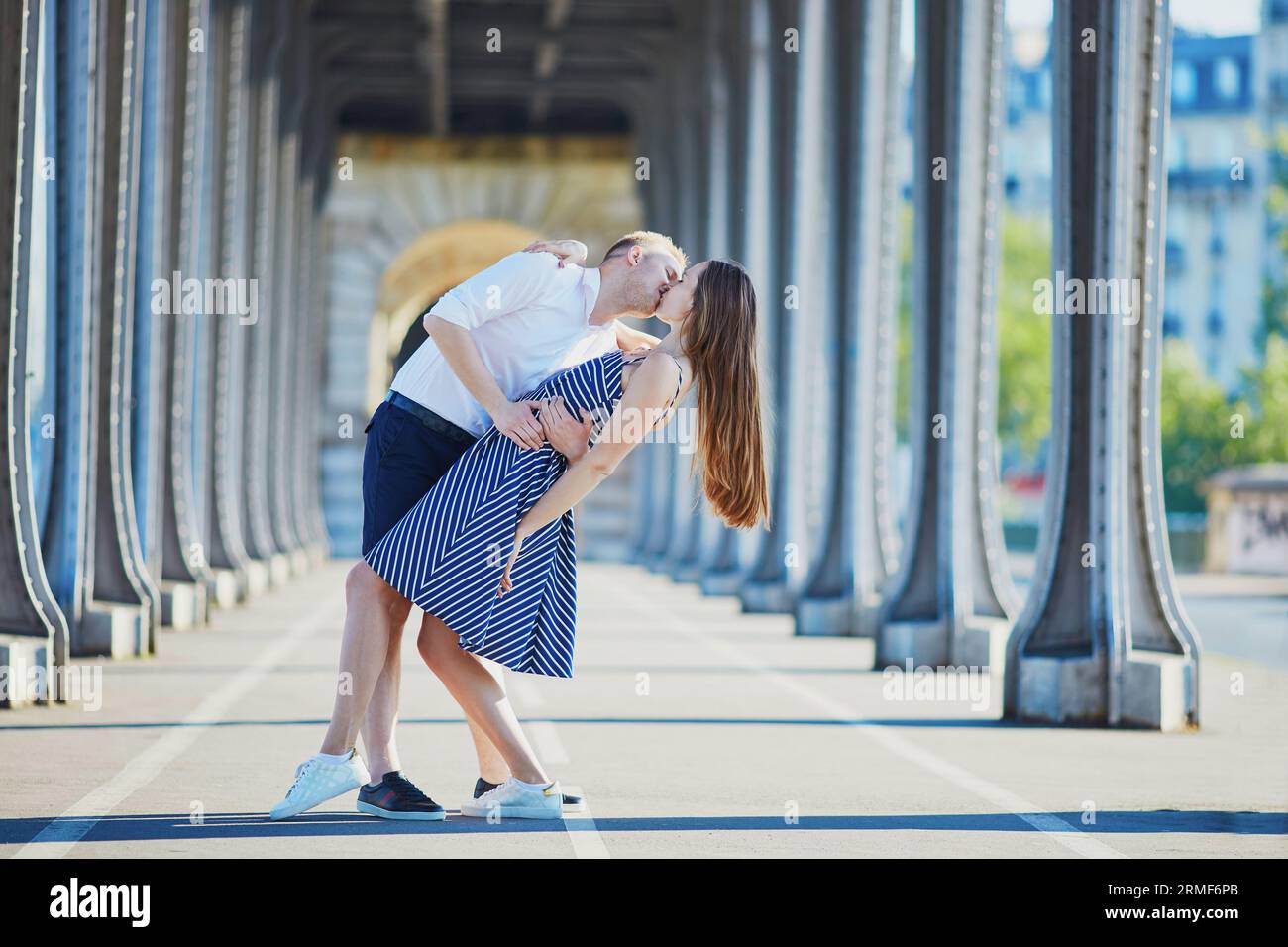 Couple kissing on bridge in paris hi-res stock photography and images ...