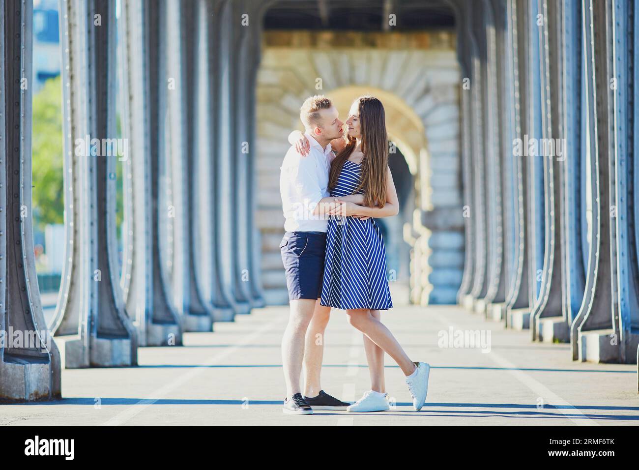 Couple kissing on bridge in paris hi-res stock photography and images ...
