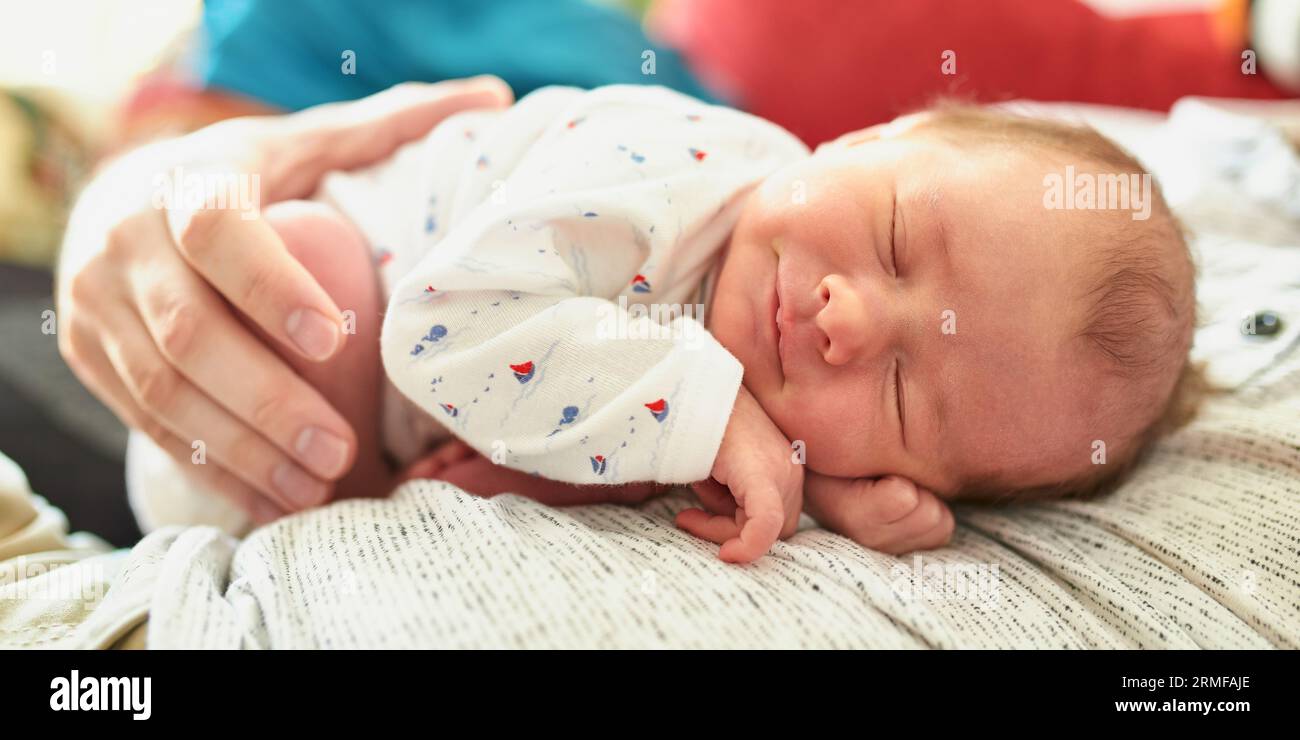 Adorable newborn baby girl sleeping on her father's chest and smiling Stock Photo Alamy