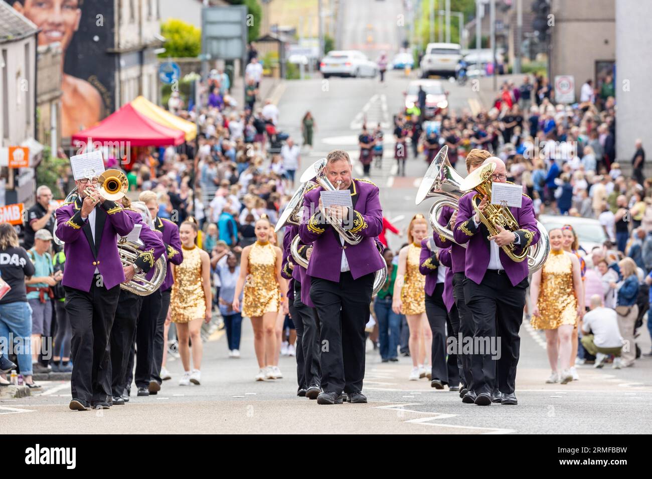 A brass band marching through the streets of Kelty before the Scottish Coal Carrying Championships Stock Photo