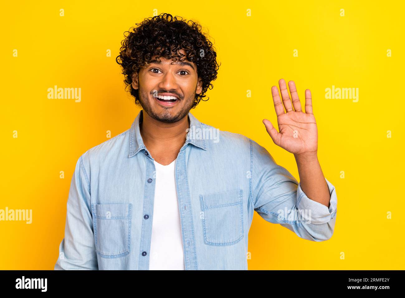 Photo of satisfied cheerful young man toothy smile arm palm waving hi ...