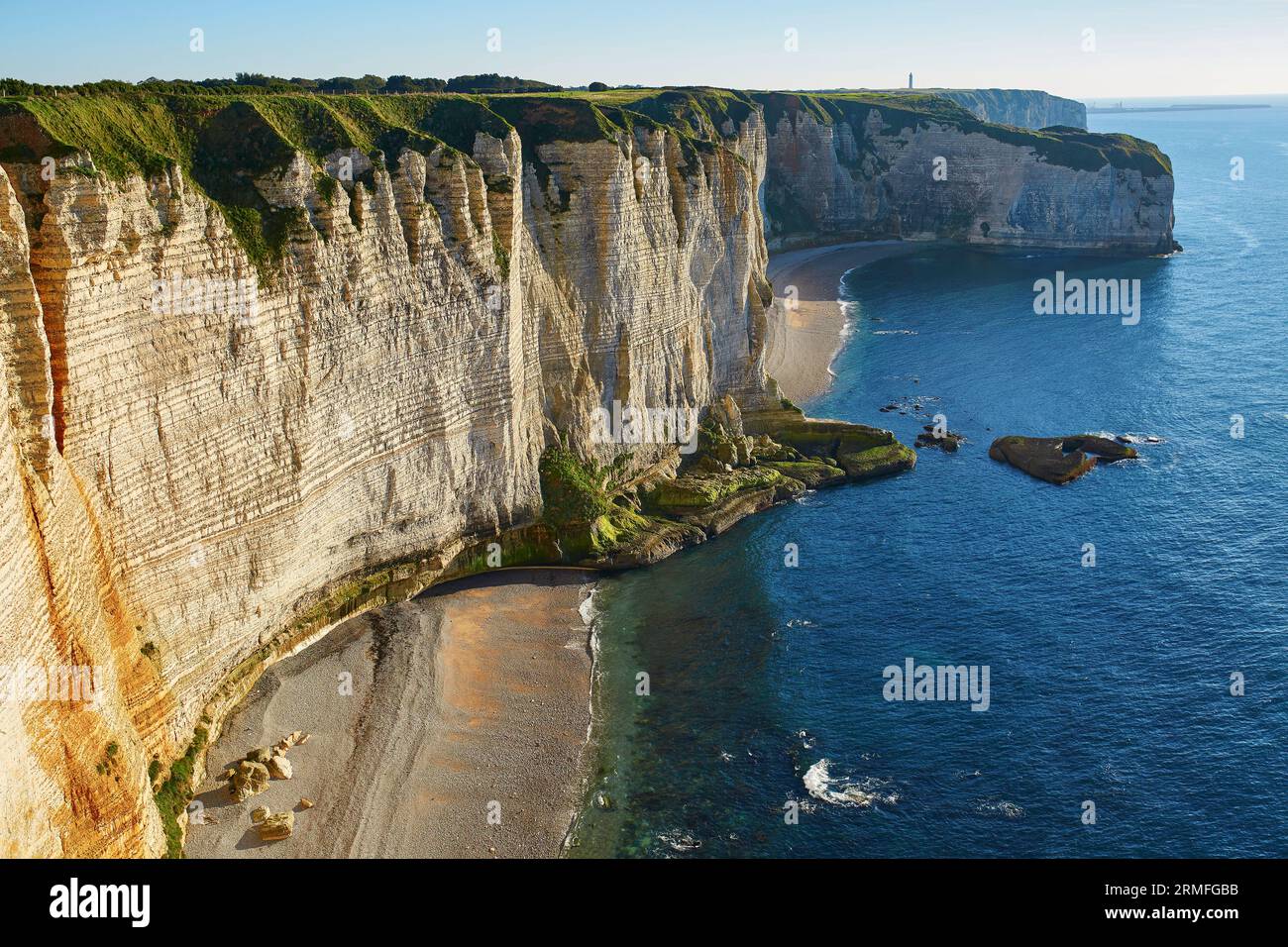Scenic view of Etretat with its beach and famous cliffs with arches ...