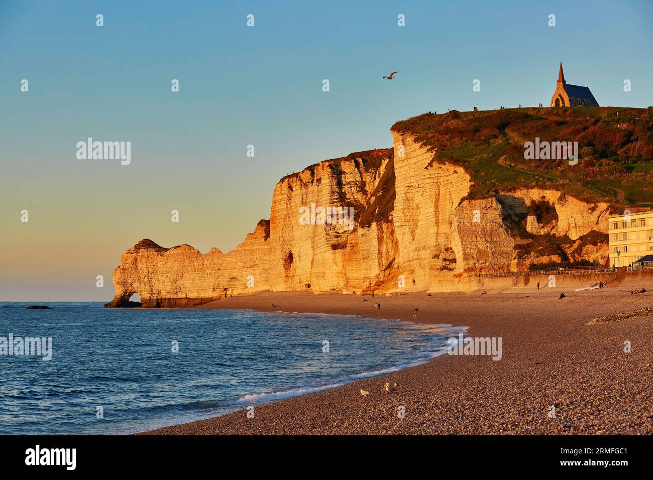 Scenic view of Etretat with its beach and famous cliffs with arches at ...