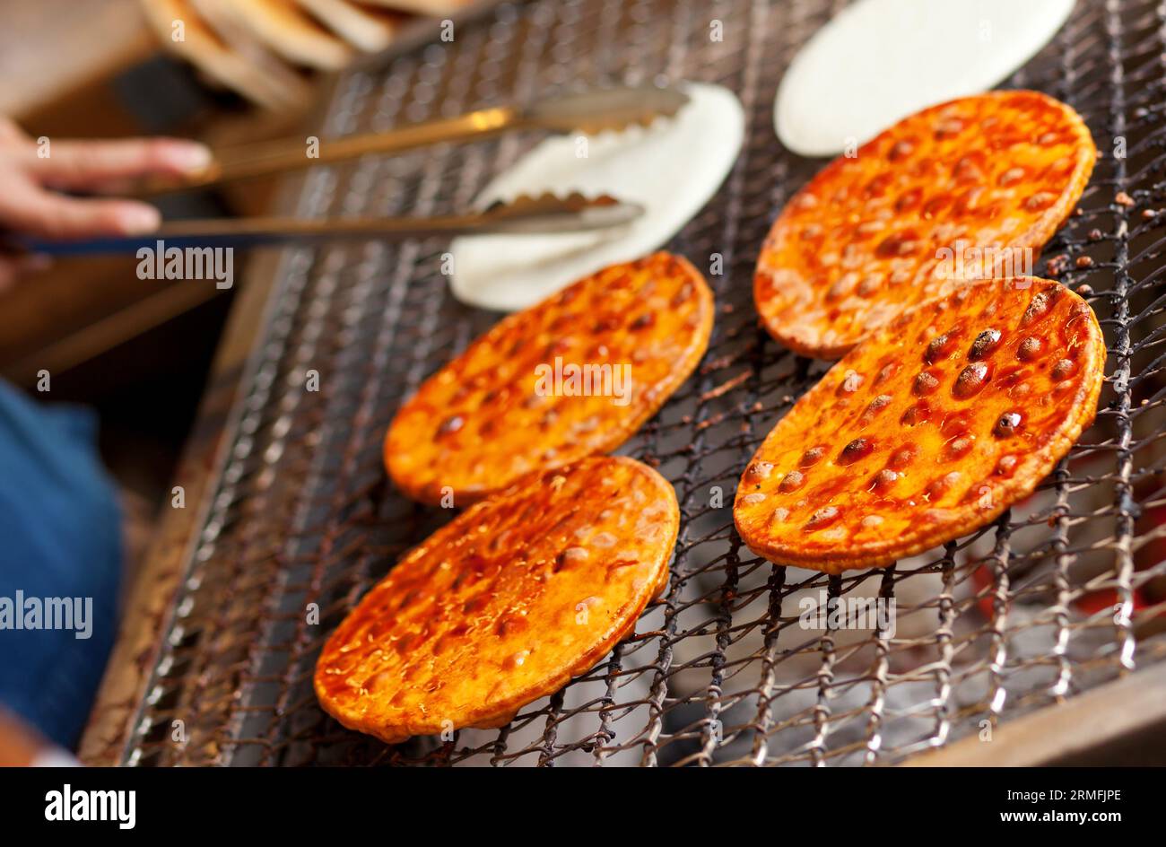 Preparing senbei, Japanese rice crackers Stock Photo - Alamy