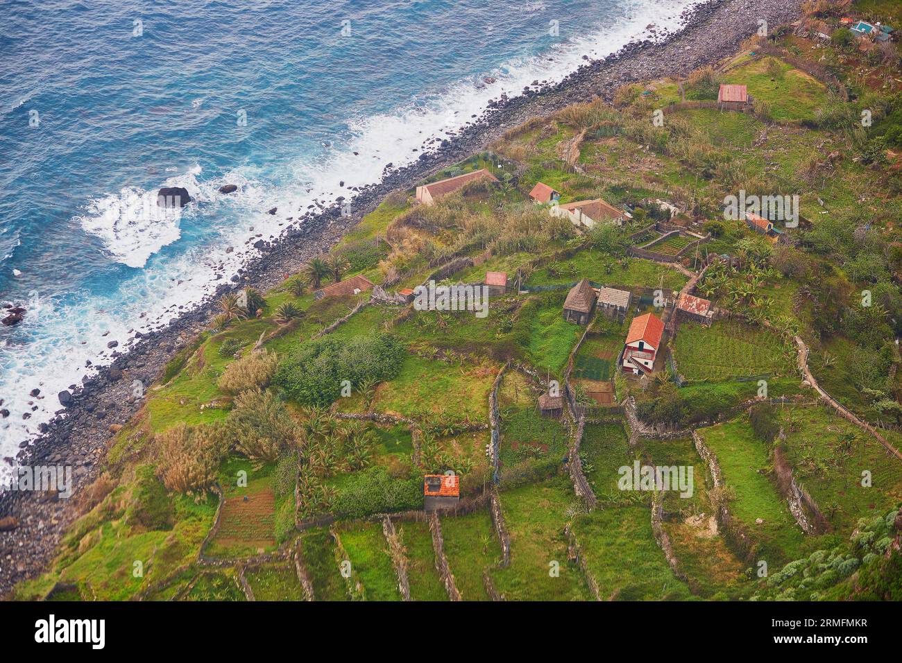 Aerial view of typical Madeira landscape with little villages, terrace fields and ocean Stock Photo