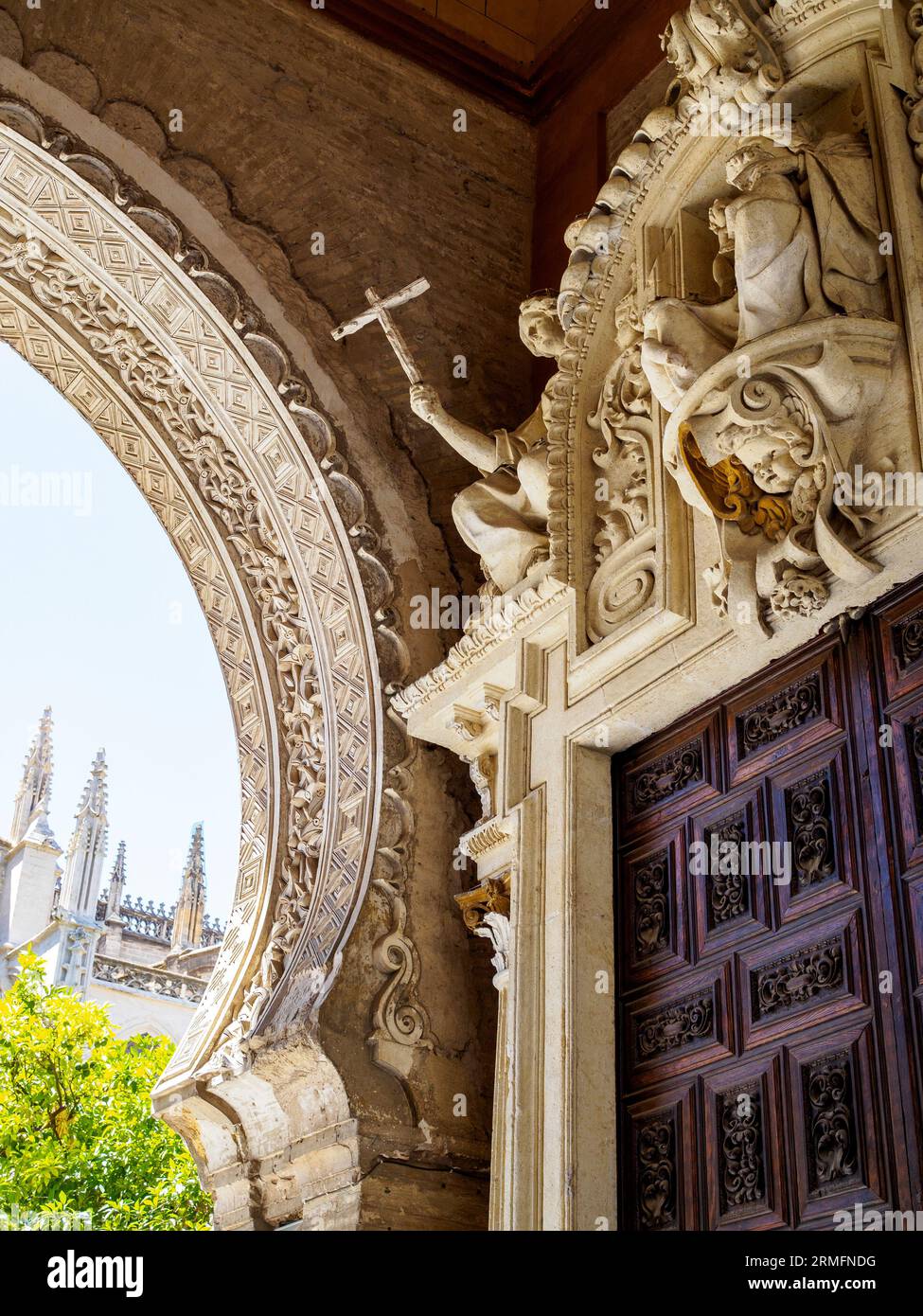 Puerta del Perdon gate, with the Patio de los naranjos courtyard in the background. North side of the Seville Cathedral. Seville, Andalusia, Spain. Stock Photo