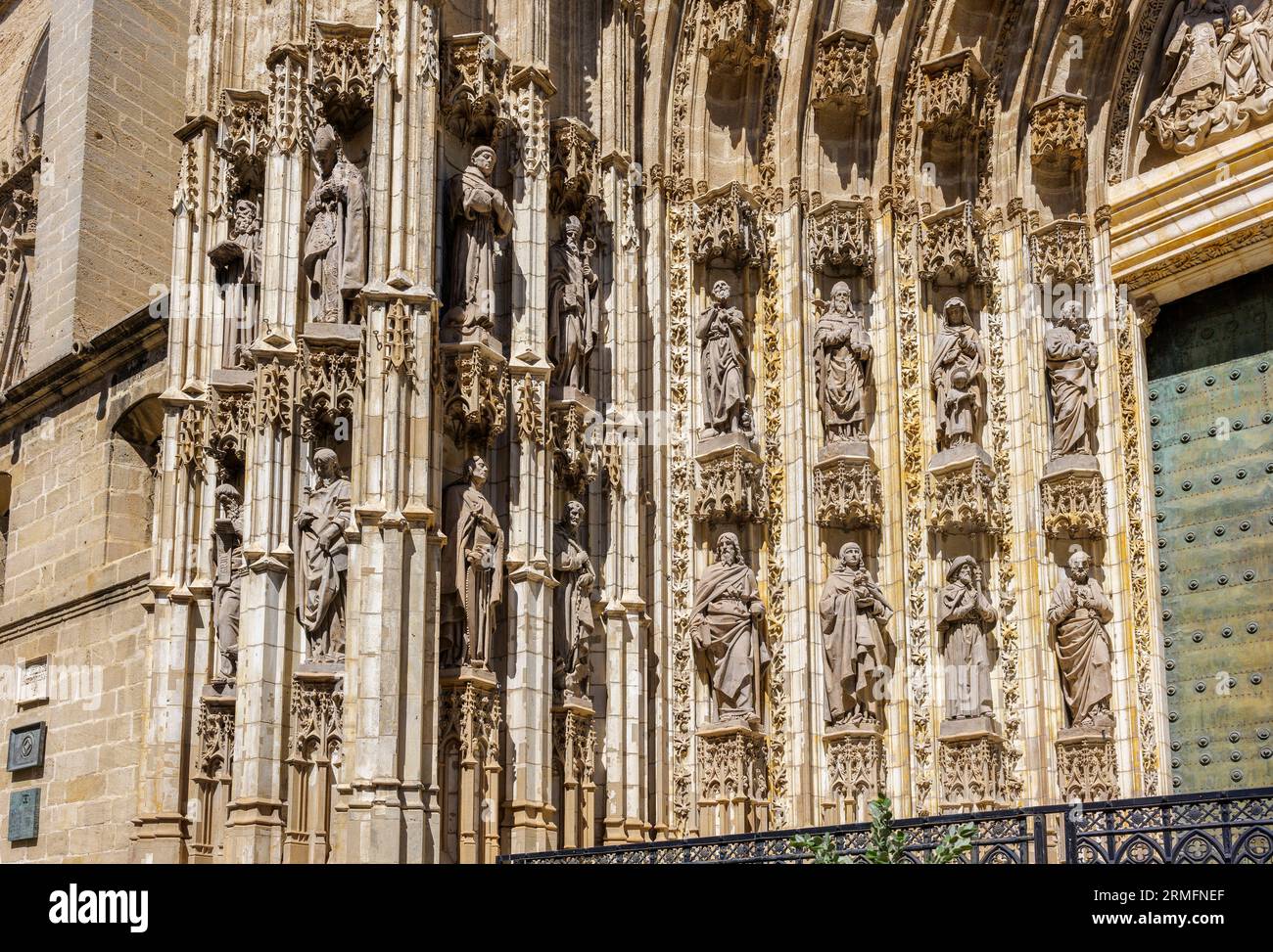 Sculptures of apostles and saints located in the niches on a side of the Puerta de la Asuncion gate, the main entrance to the Seville Cathedral. Spain Stock Photo