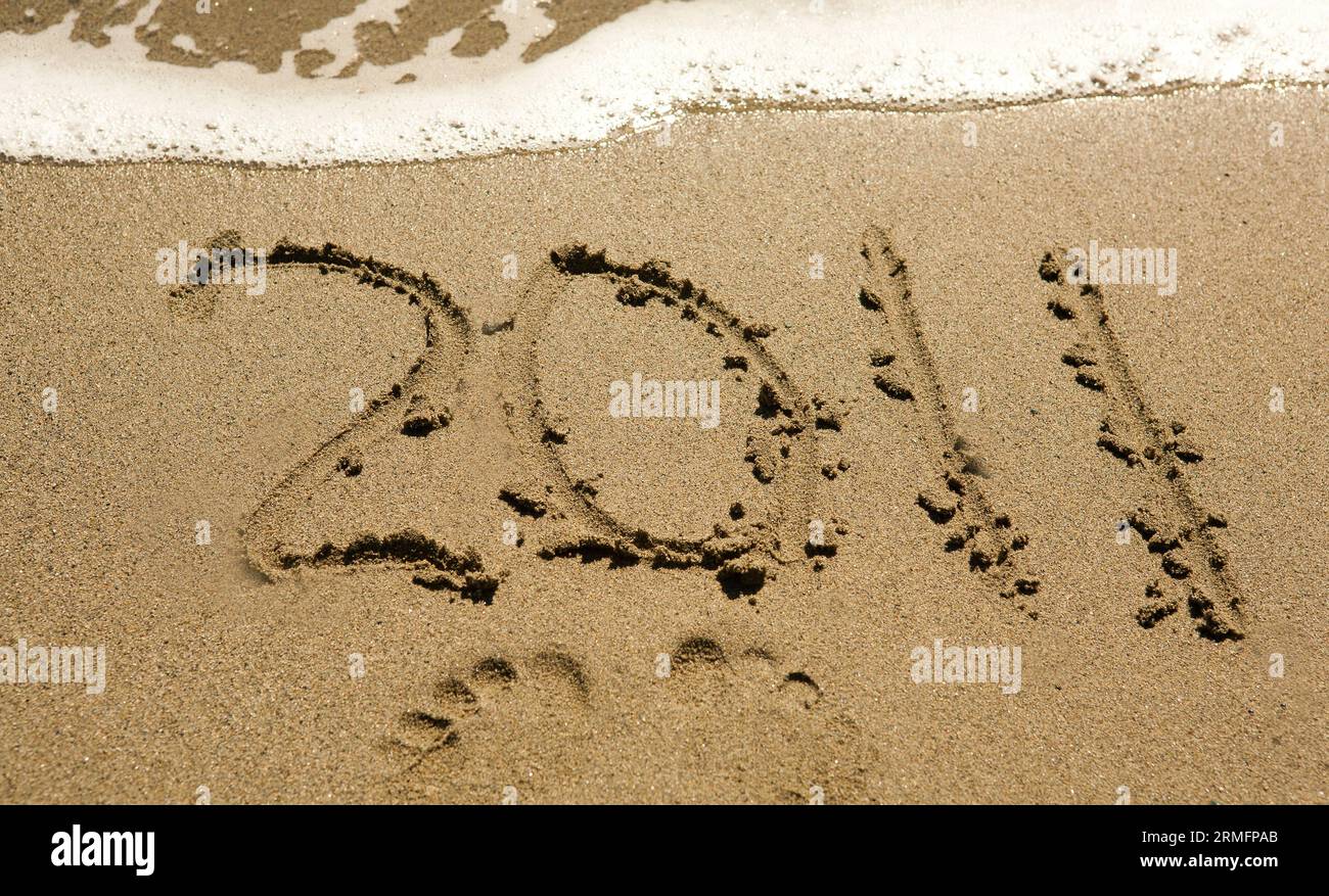 Happy new year 2011! 2011 and footprints on a beach Stock Photo