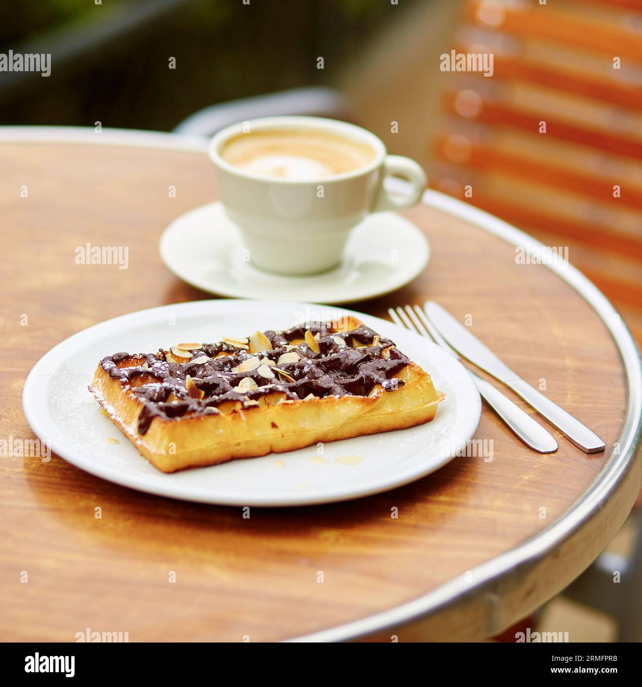 Delicious Belgian waffles with chocolate in an outdoor Parisian restaurant Stock Photo