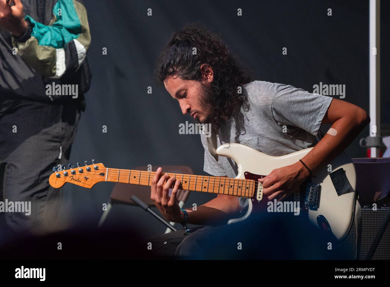 Simon Martinez plays guitar with Salami Rose Joe Louis at Green Man