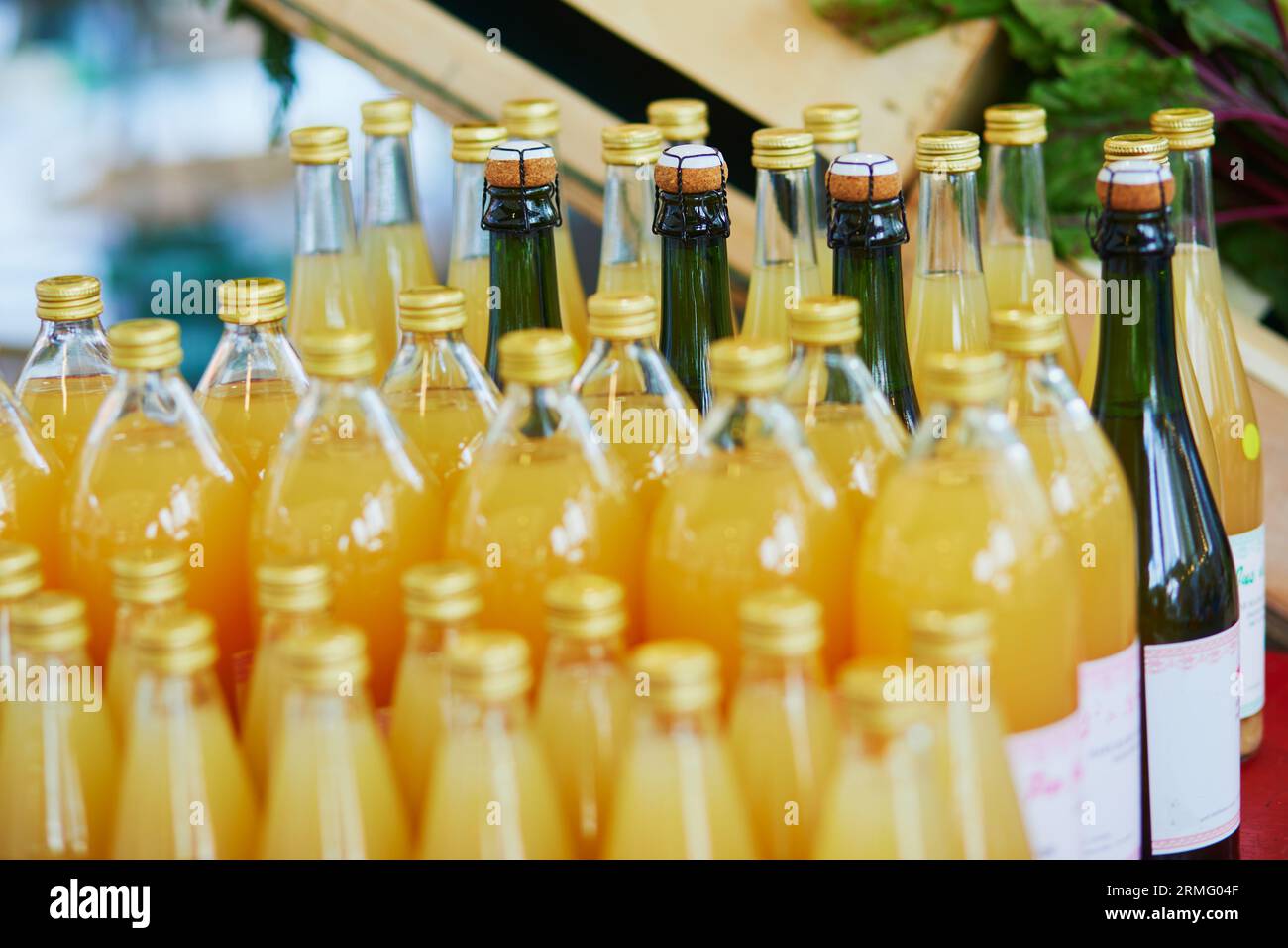 Bottles with apple juice and cider on farmer market in Paris, France