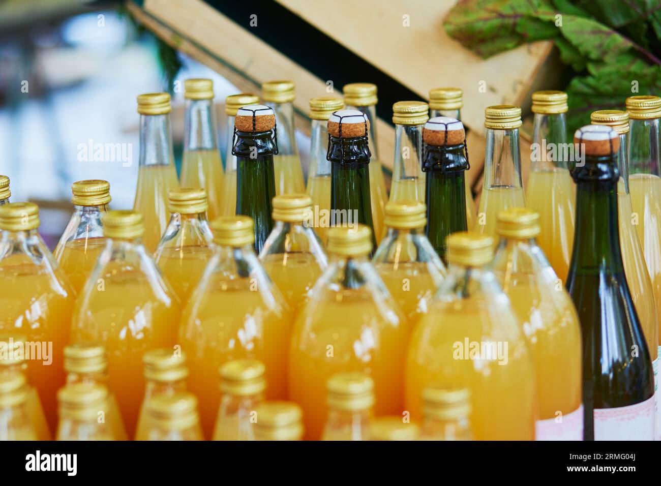 Bottles with apple juice and cider on farmer market in Paris, France. Typical European market of