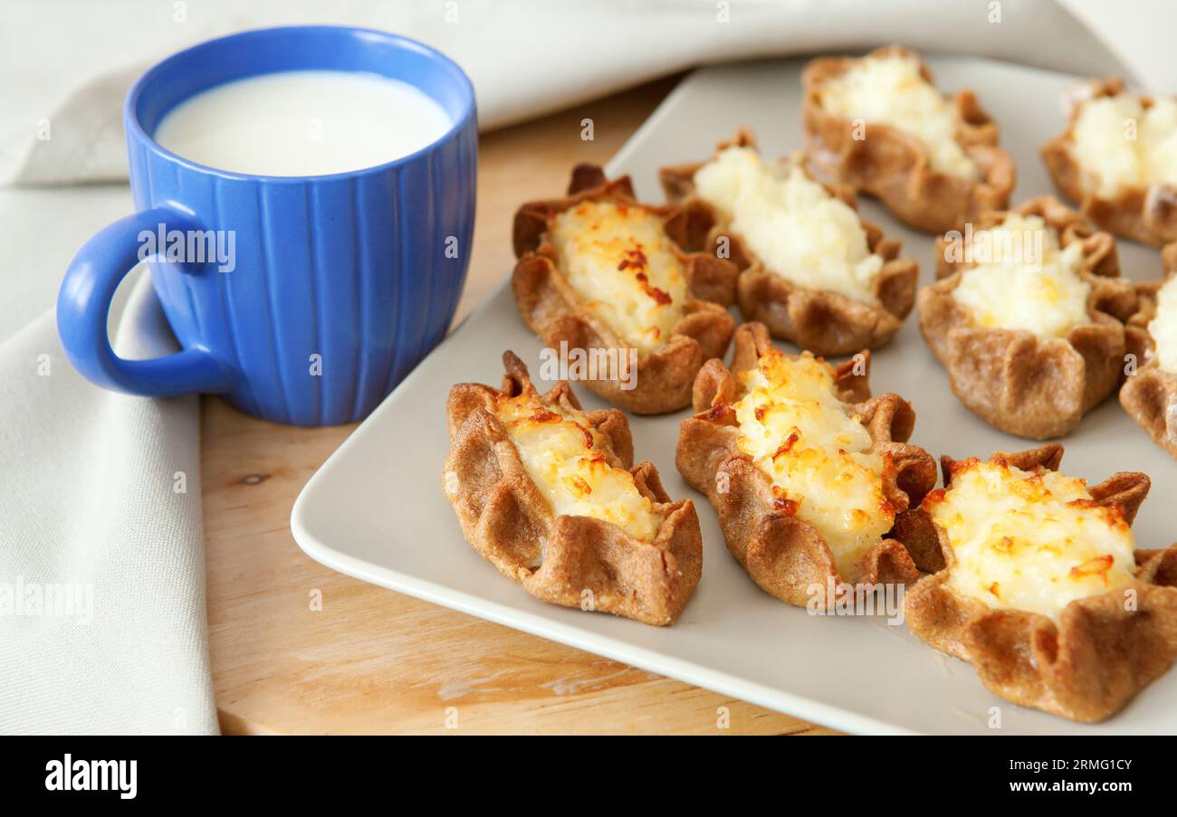 Traditional karelian pasties and cup of milk for breakfast Stock Photo