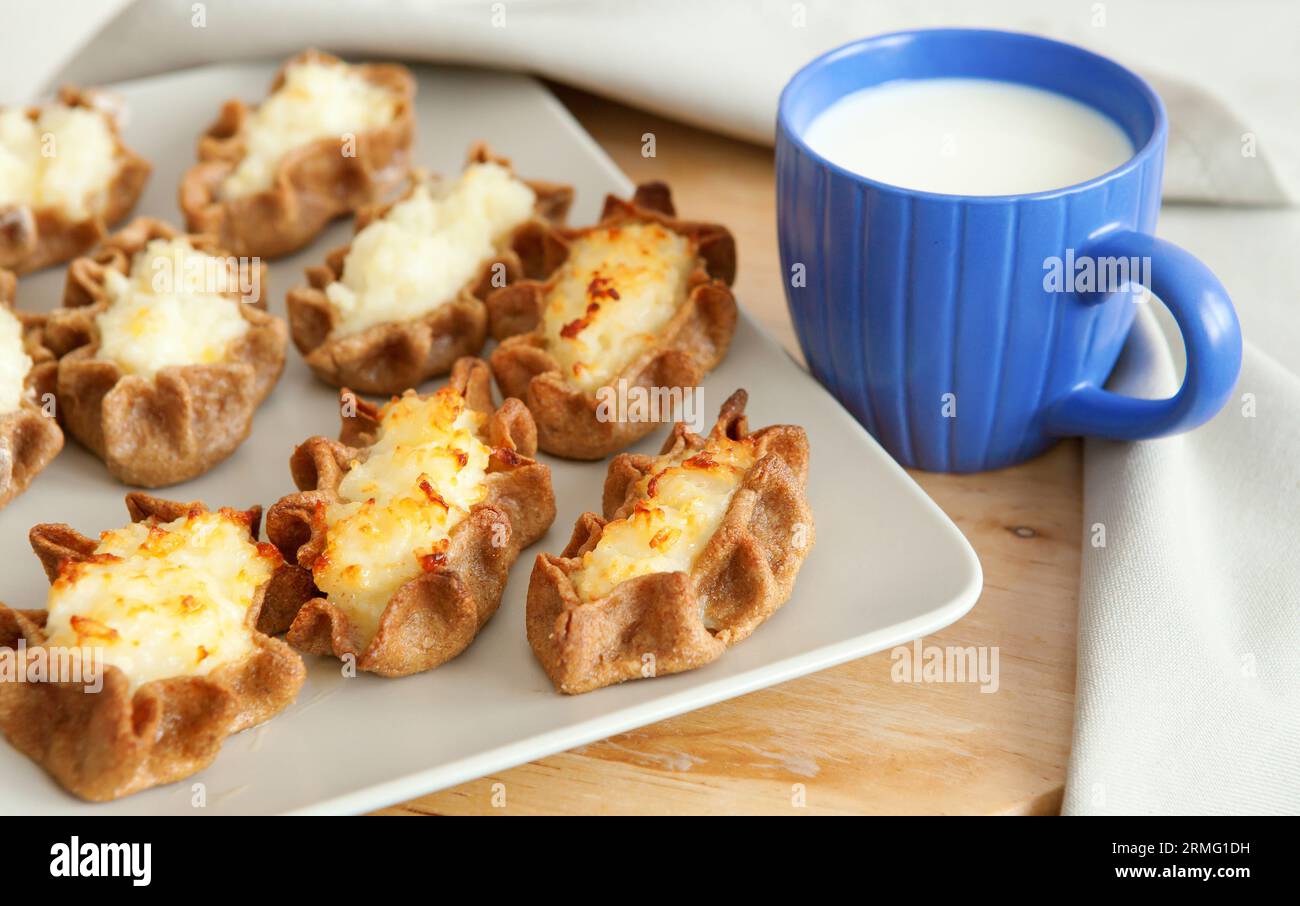 Traditional karelian pasties and cup of milk for breakfast Stock Photo