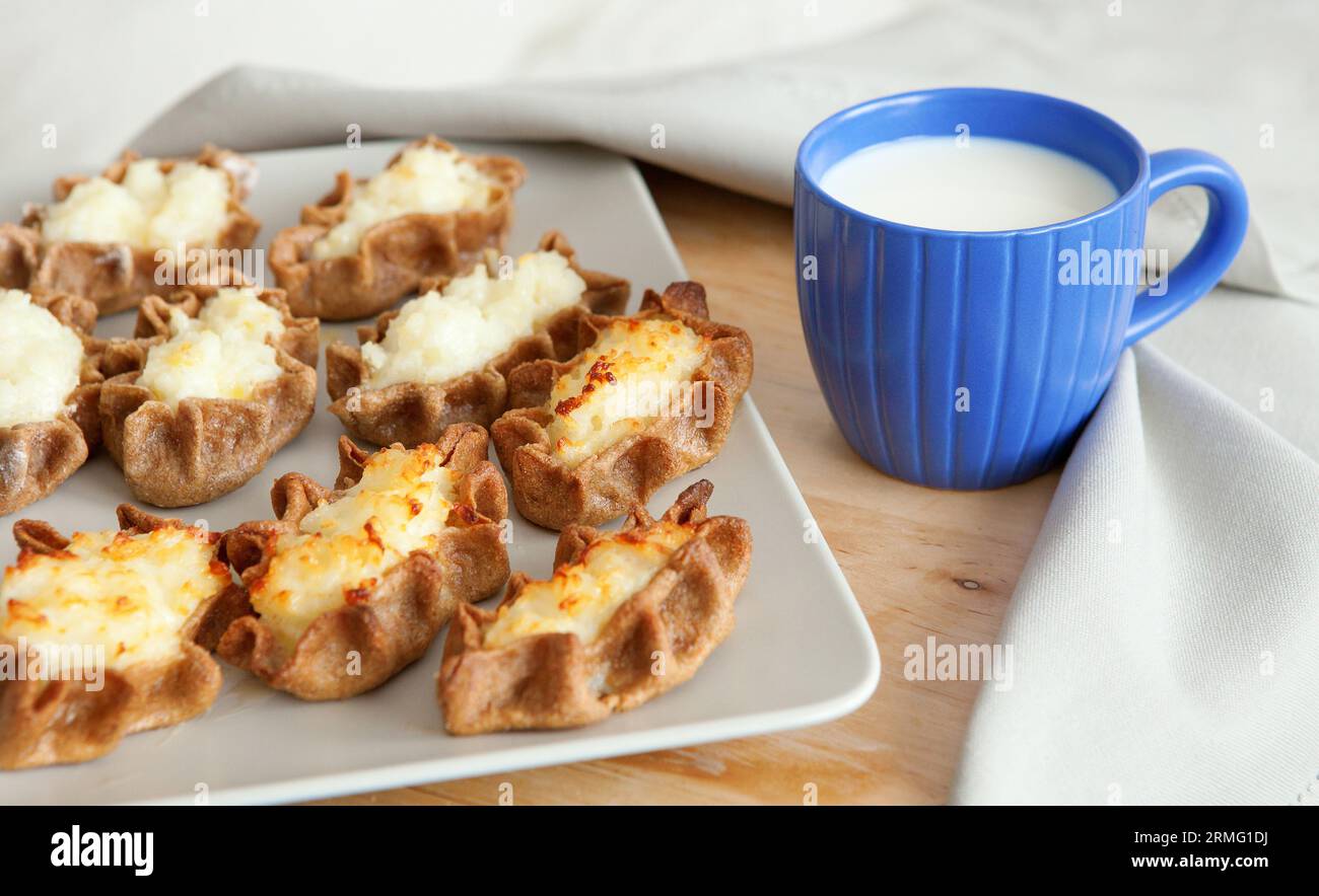 Traditional karelian pasties with cup of milk Stock Photo