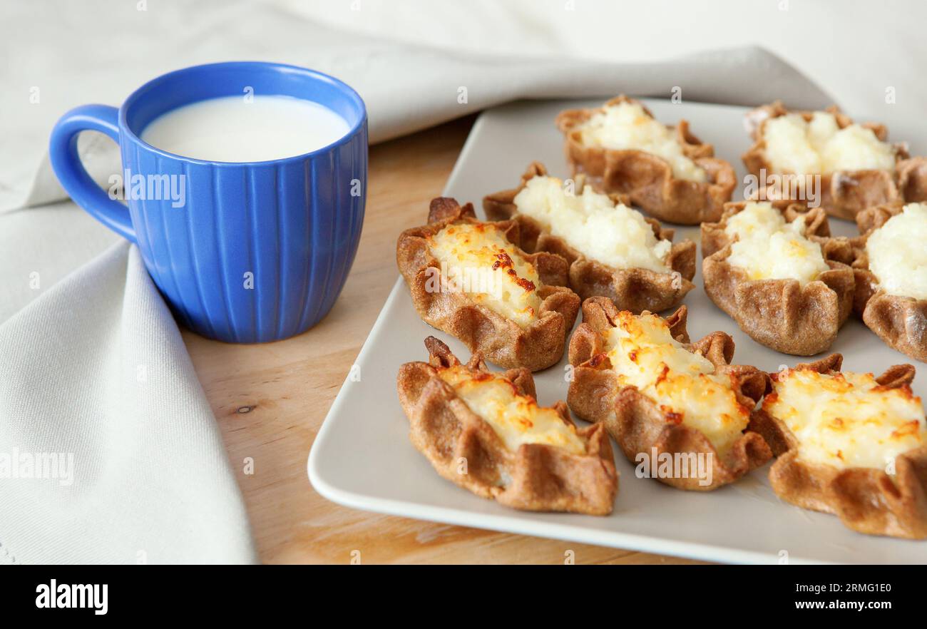 Traditional karelian pasties with cup of milk Stock Photo