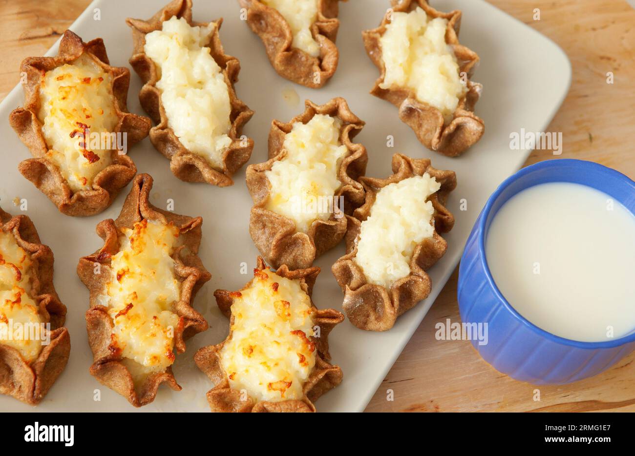 Traditional karelian pasties from Finland with cup of milk Stock Photo