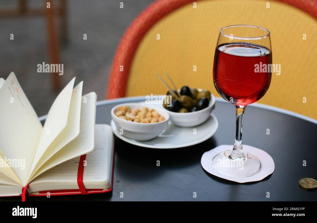 Parisian street cafe table with traditional French aperitif kir cassis