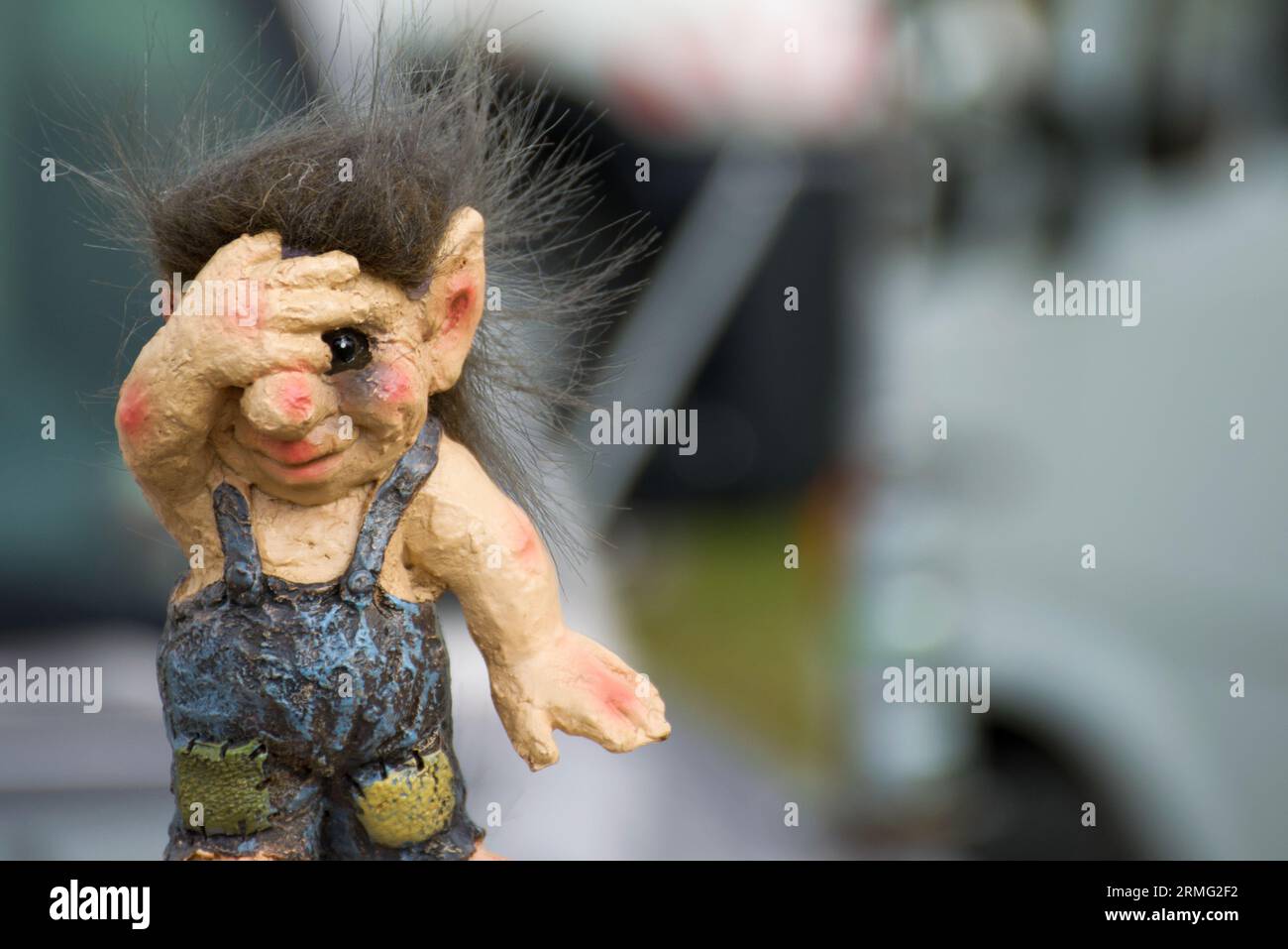 A small Norwegian troll covering his eyes. Trolls are famous creatures in Scandinavian myth. Very detailed image with copyspace. Stock Photo