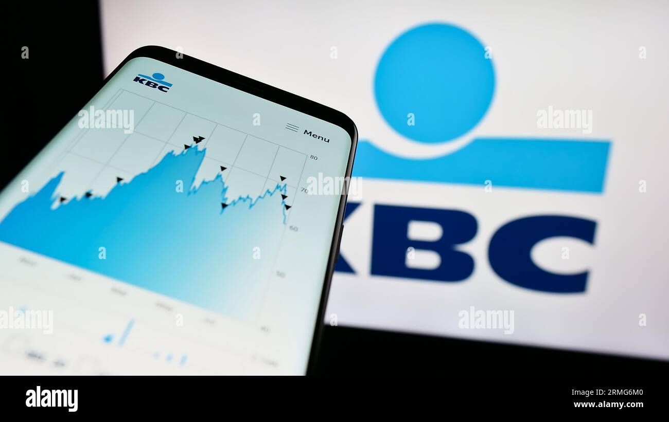 Smartphone with webpage of Belgian financial company KBC Group N.V.  on screen in front of business logo. Focus on top-left of phone display. Stock Photo