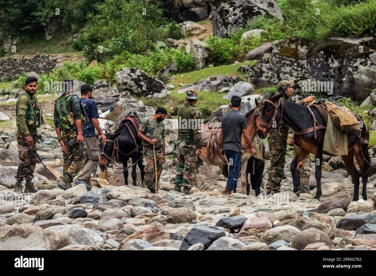 Indian army soldiers seen with their horses as they prepare to head towards their bunkers, at Neelam river or Kishan Ganga that has divided Kashmir into two parts controlled by nuclear rivals India and Pakistan. The river acts as a disputed line of control and flows through a village called Keran from both sides which is located on the northern side of Indian Kashmir's Border district Kupwara some 150kms from Srinagar and 93kms from Muzaffarabad, in the Pakistan side of Kashmir. (Photo by Faisal Bashir/SOPA Images/Sipa USA) Stock Photo