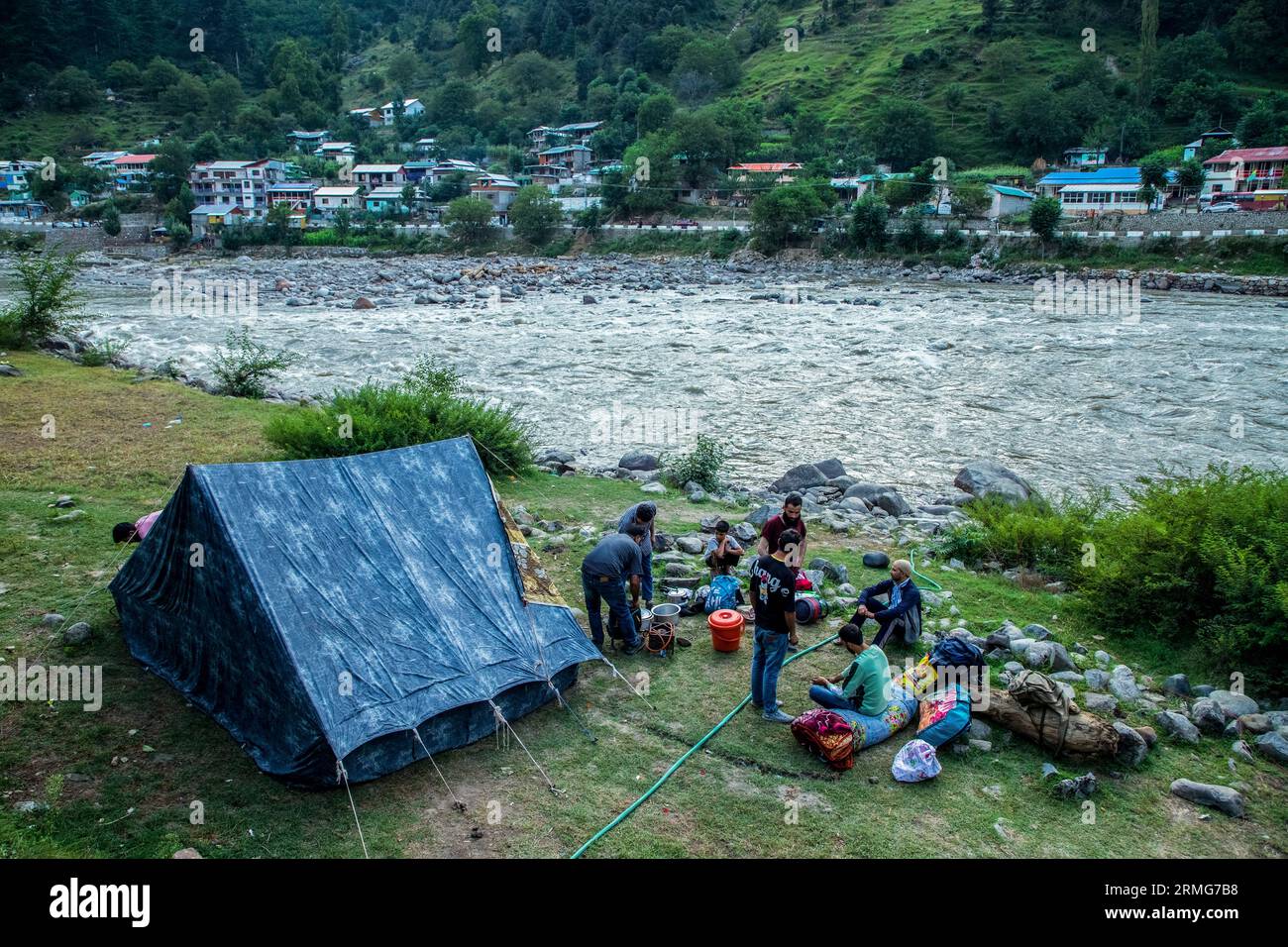 Keran Kupwara, India. 24th Aug, 2023. People are seen camping on the banks of Neelam river or Kishan Ganga that has divided Kashmir into two parts controlled by nuclear rivals India and Pakistan. The river acts as a disputed line of control and flows through a village called Keran from both sides which is located on the northern side of Indian Kashmir's Border district Kupwara some 150kms from Srinagar and 93kms from Muzaffarabad, in the Pakistan side of Kashmir. (Photo by Faisal Bashir/SOPA Images/Sipa USA) Credit: Sipa USA/Alamy Live News Stock Photo