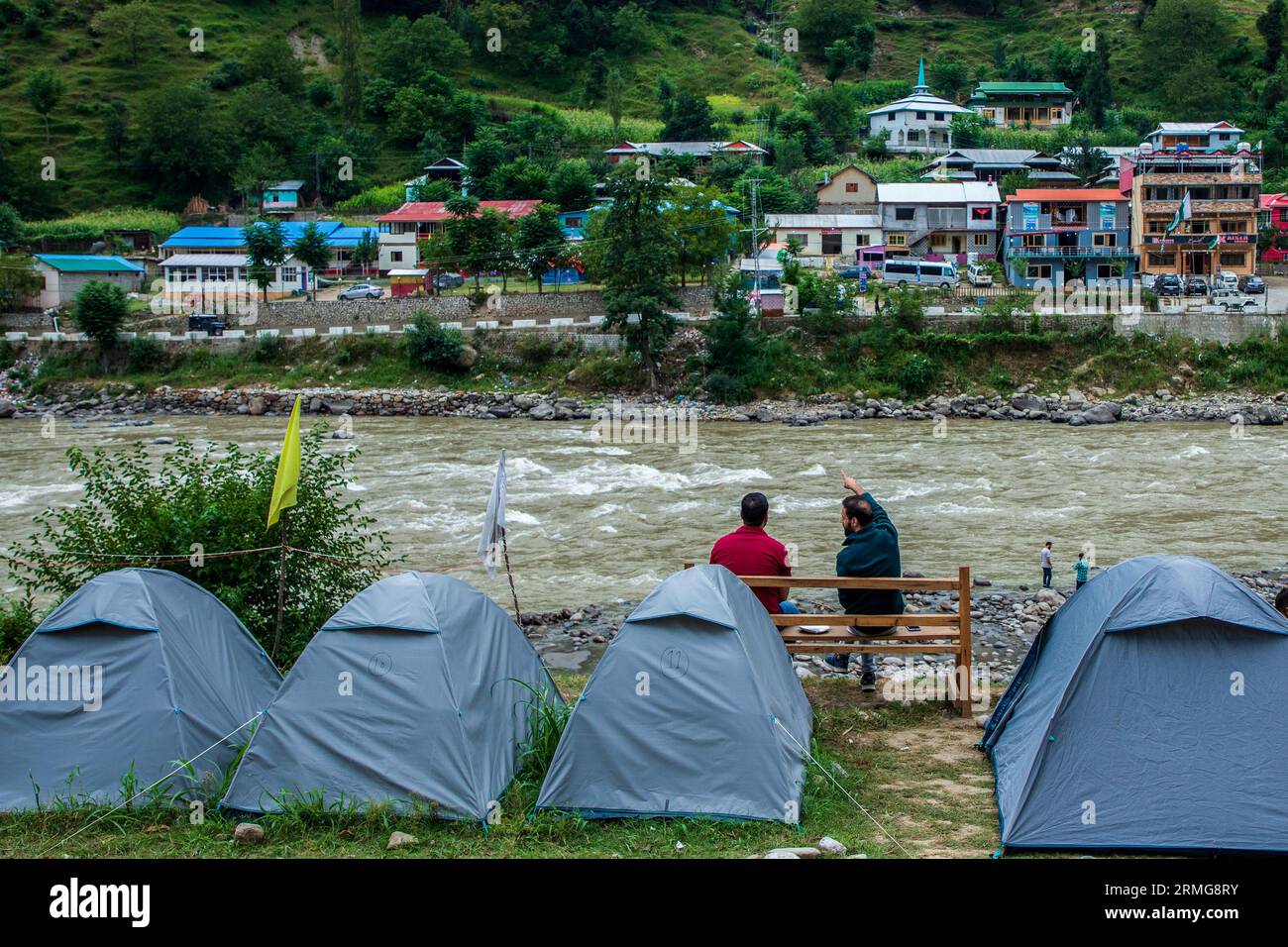 August 25, 2023, Keran Kupwara, Jammu and Kashmir, India: Camping tents are installed on the banks of Neelam river or Kishan Ganga that has divided Kashmir into two parts controlled by nuclear rivals India and Pakistan. The river acts as a disputed line of control and flows through a village called Keran from both sides which is located on the northern side of Indian Kashmir's Border district Kupwara some 150kms from Srinagar and 93kms from Muzaffarabad, in the Pakistan side of Kashmir. (Credit Image: © Faisal Bashir/SOPA Images via ZUMA Press Wire) EDITORIAL USAGE ONLY! Not for Commercial USA Stock Photo