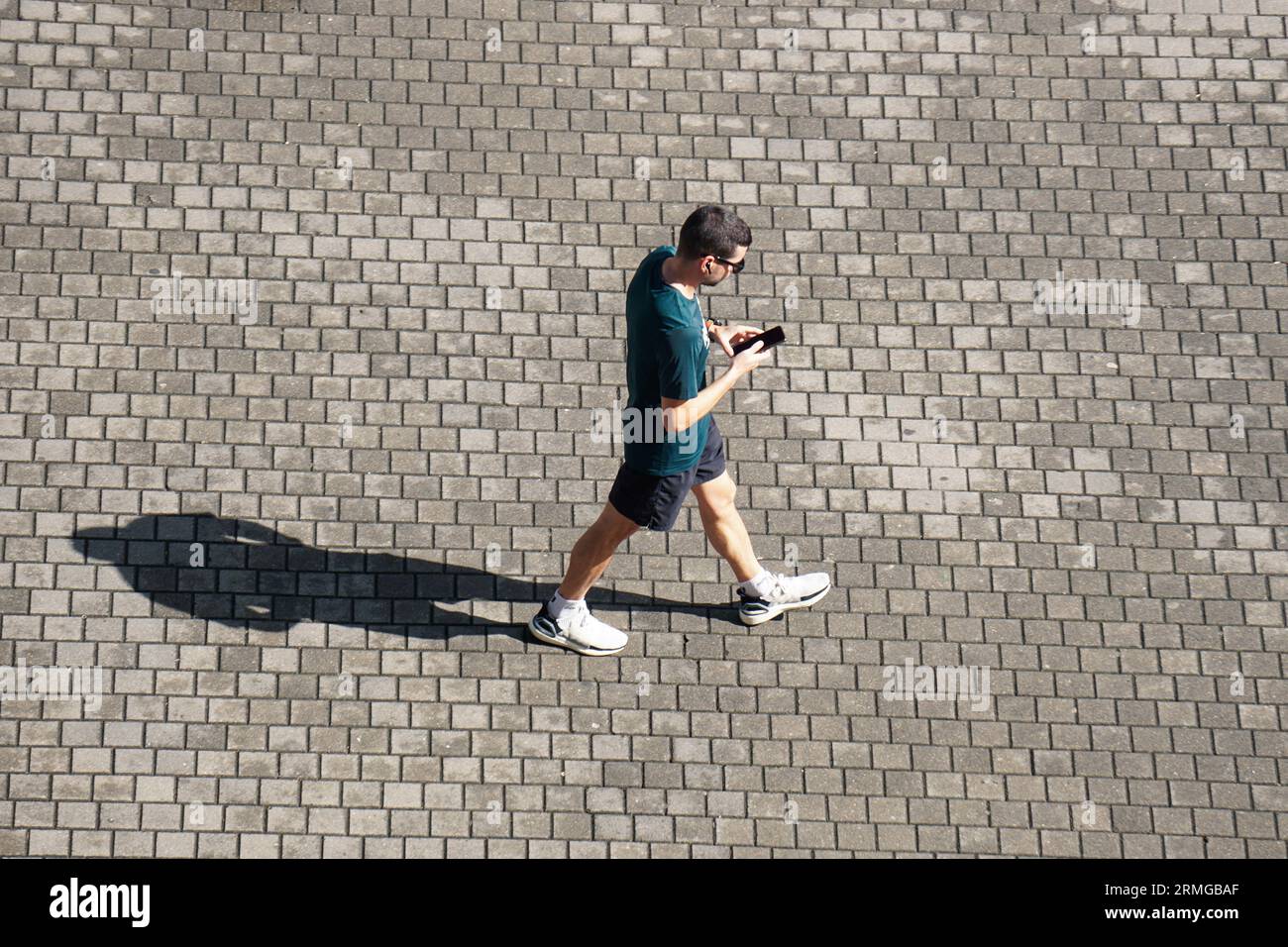 person walking on the street and texting with the smartphone Stock Photo