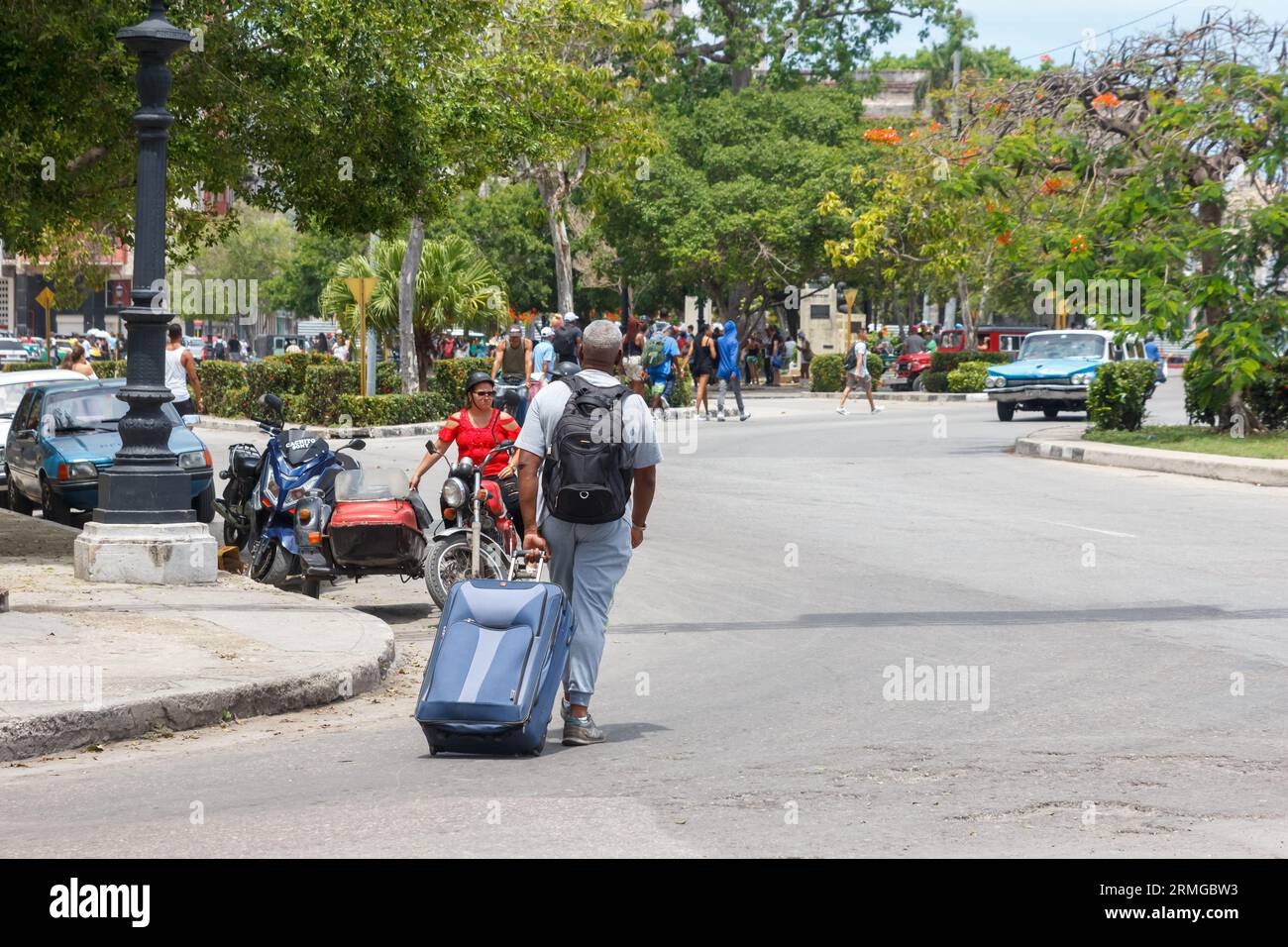 Havana, Cuba, 2023, Man pulling a wheeled suitcase Stock Photo
