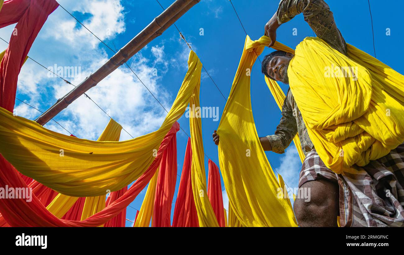 Dyed clothes of different colors are dried in the sun Stock Photo Alamy