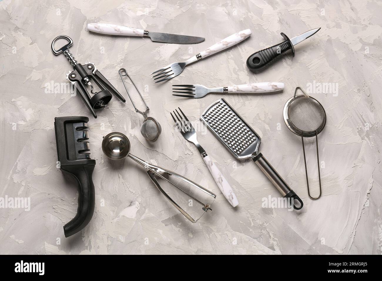 Different kitchen utensils on grey background Stock Photo