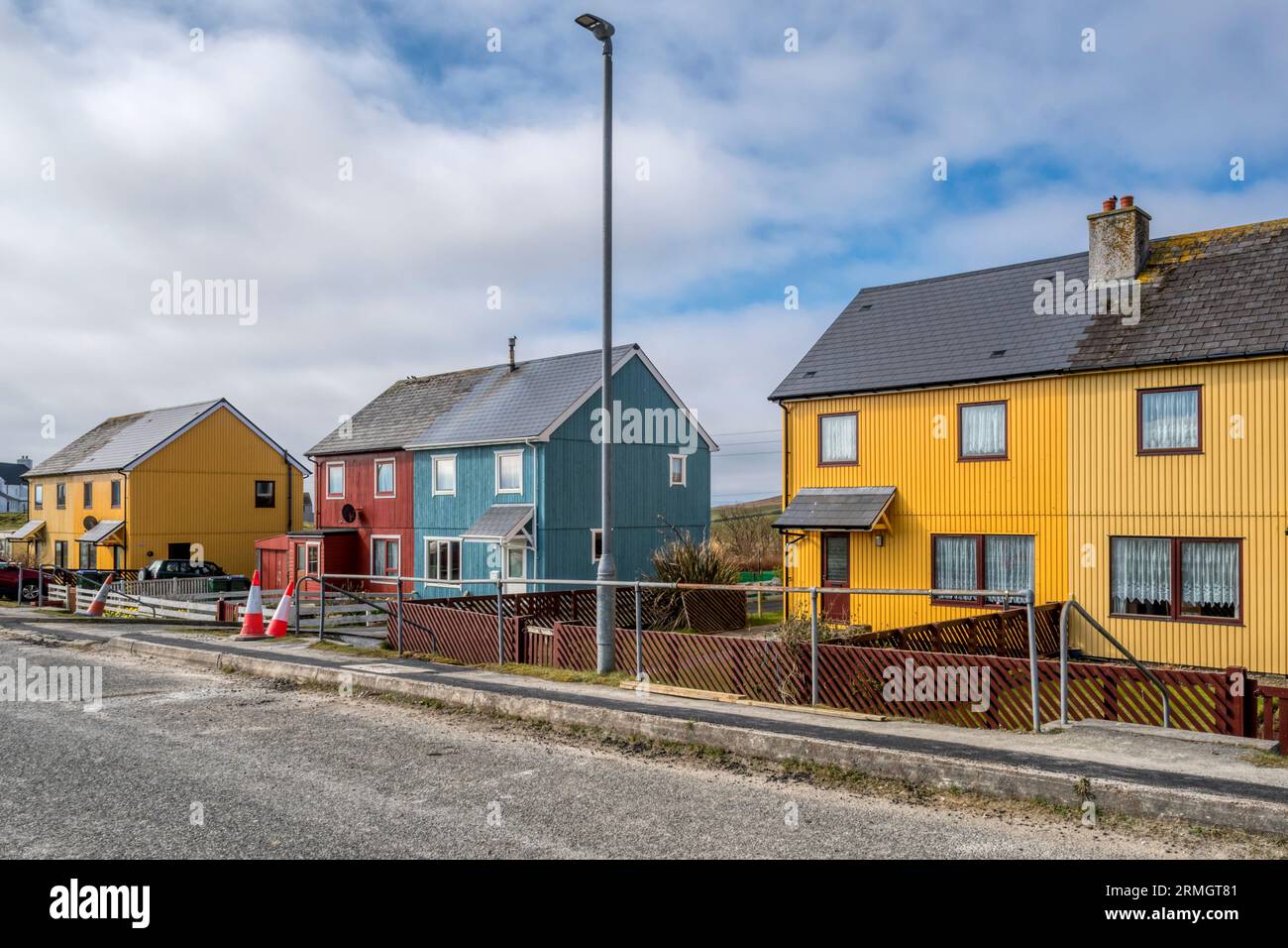 Bright coloured cladding on houses at Burravoe in the south of the