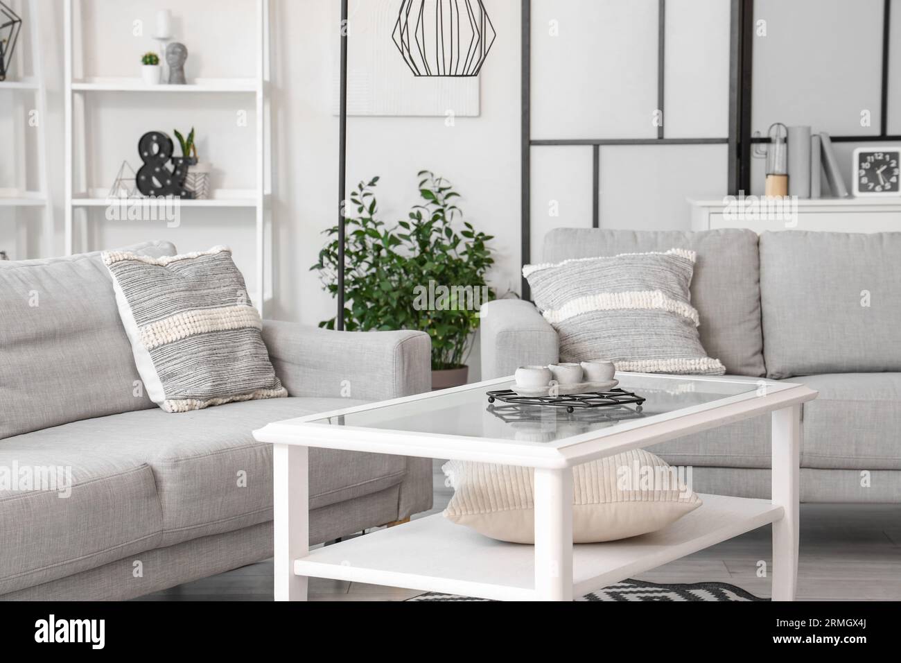 Interior of light living room with grey sofas and coffee table Stock ...