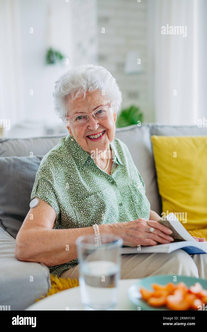 Diabetic senior patient using continuous glucose monitor to check blood