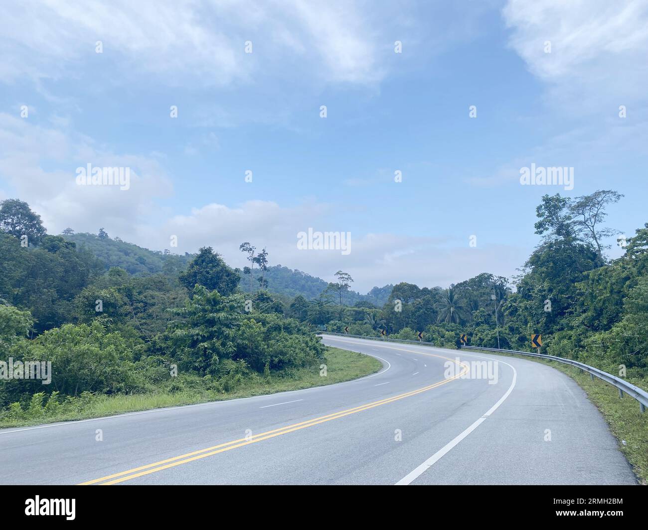 road asphalt in the forest nature countryside of Thailand, road environment high voltage electric pol. tree jungle travel green landscape. road way. Stock Photo