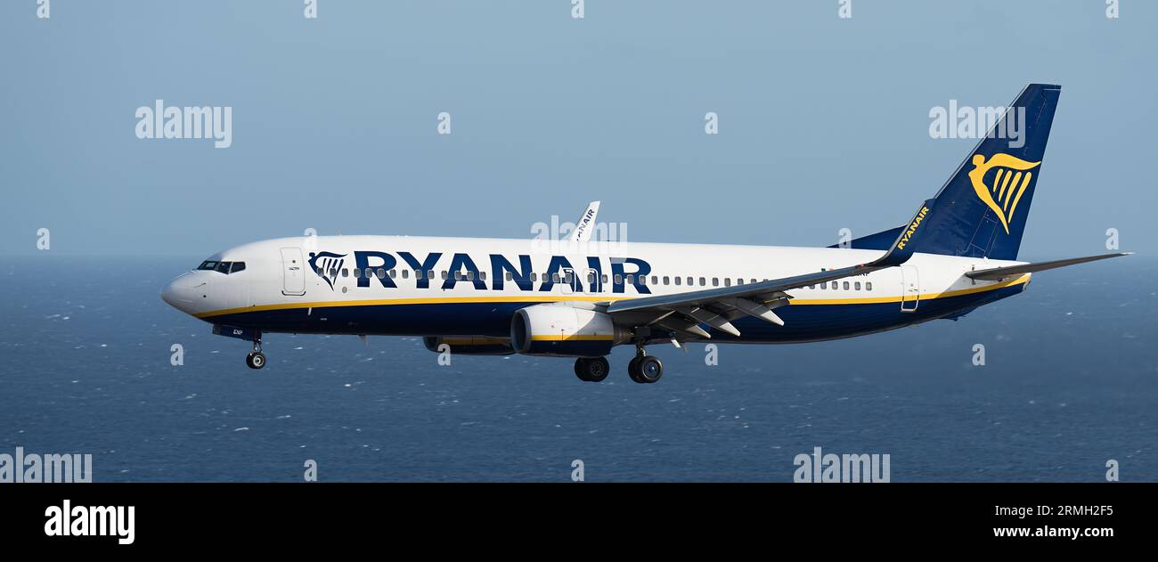 Tenerife, Spain august 4 st, 2023. Boeing 737-8AS of Ryanair Airlines flies in the blue sky over the ocean Stock Photo