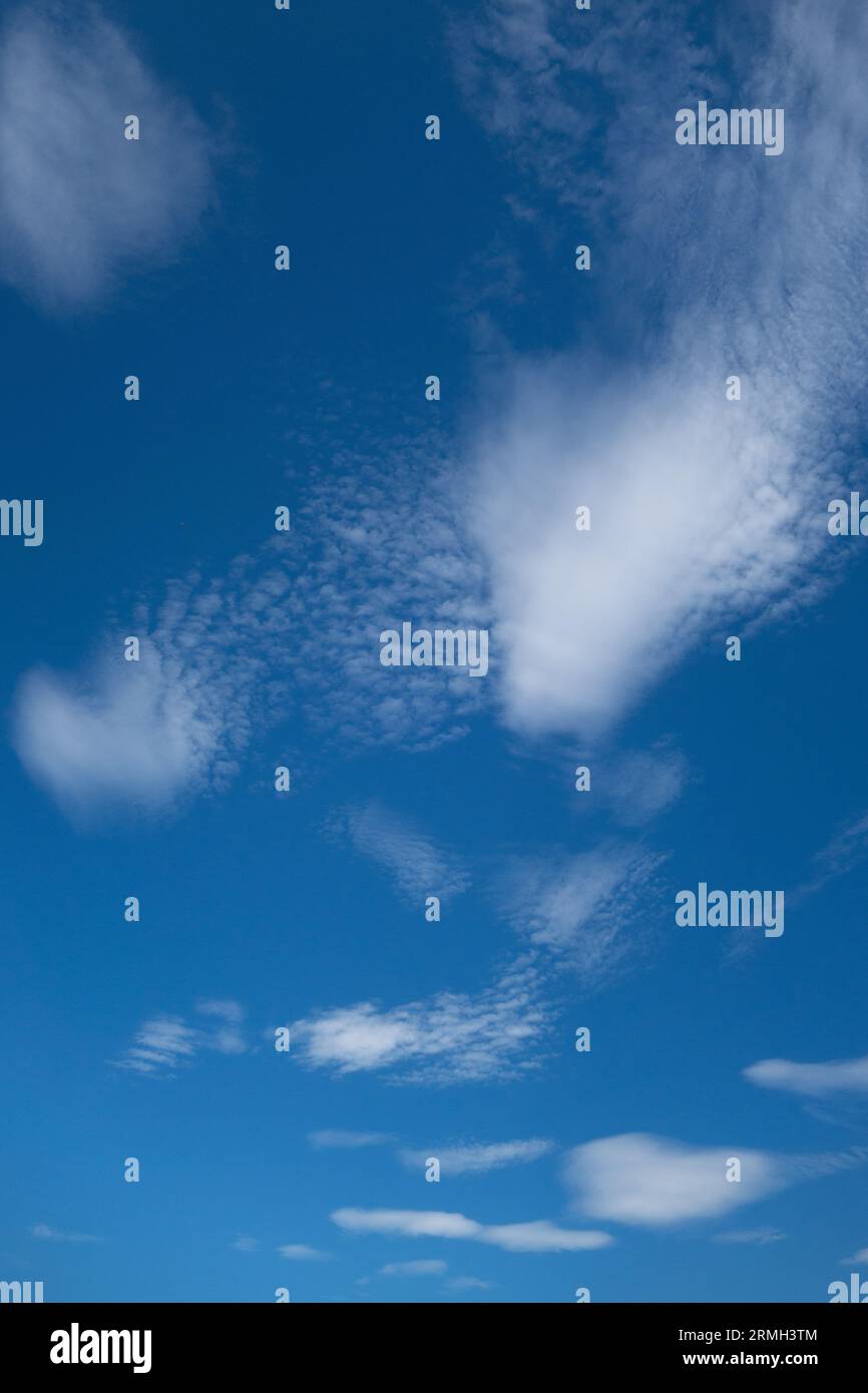 Cute wispy clouds in a blue sky. Stock Photo