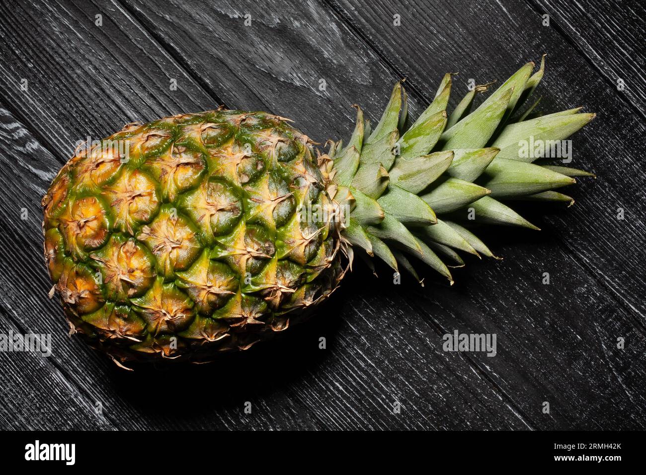 single pineapple on wood background Stock Photo