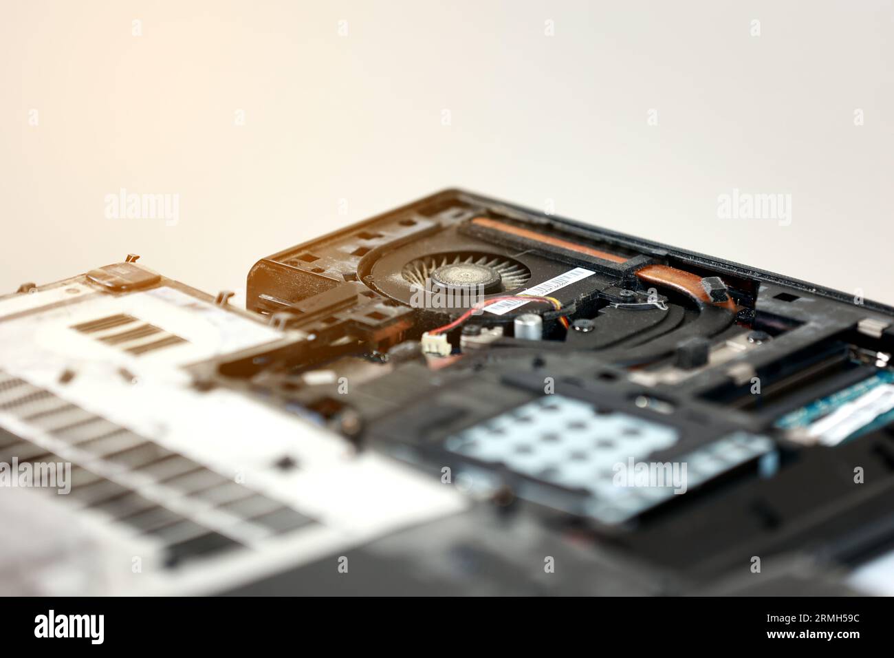 Fixing laptop. Repairman holds cooling fan and repairs from overheating