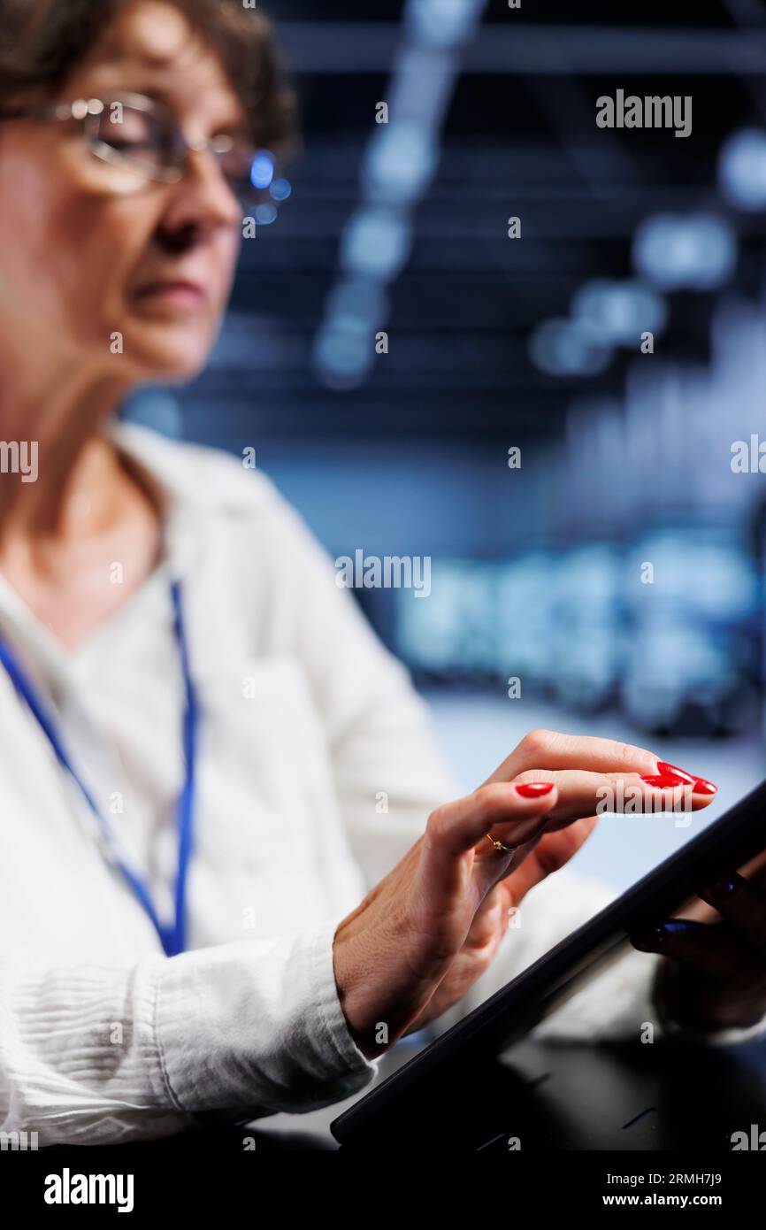 Licensed computer operator using tablet to assess server security ...