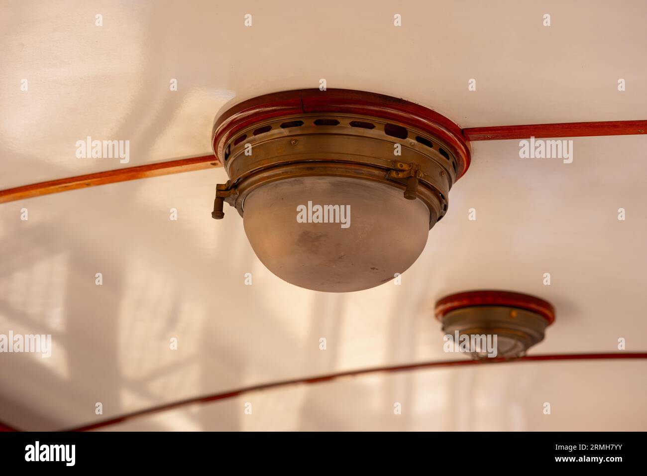 Two old lamps on the ceiling of a train car Stock Photo