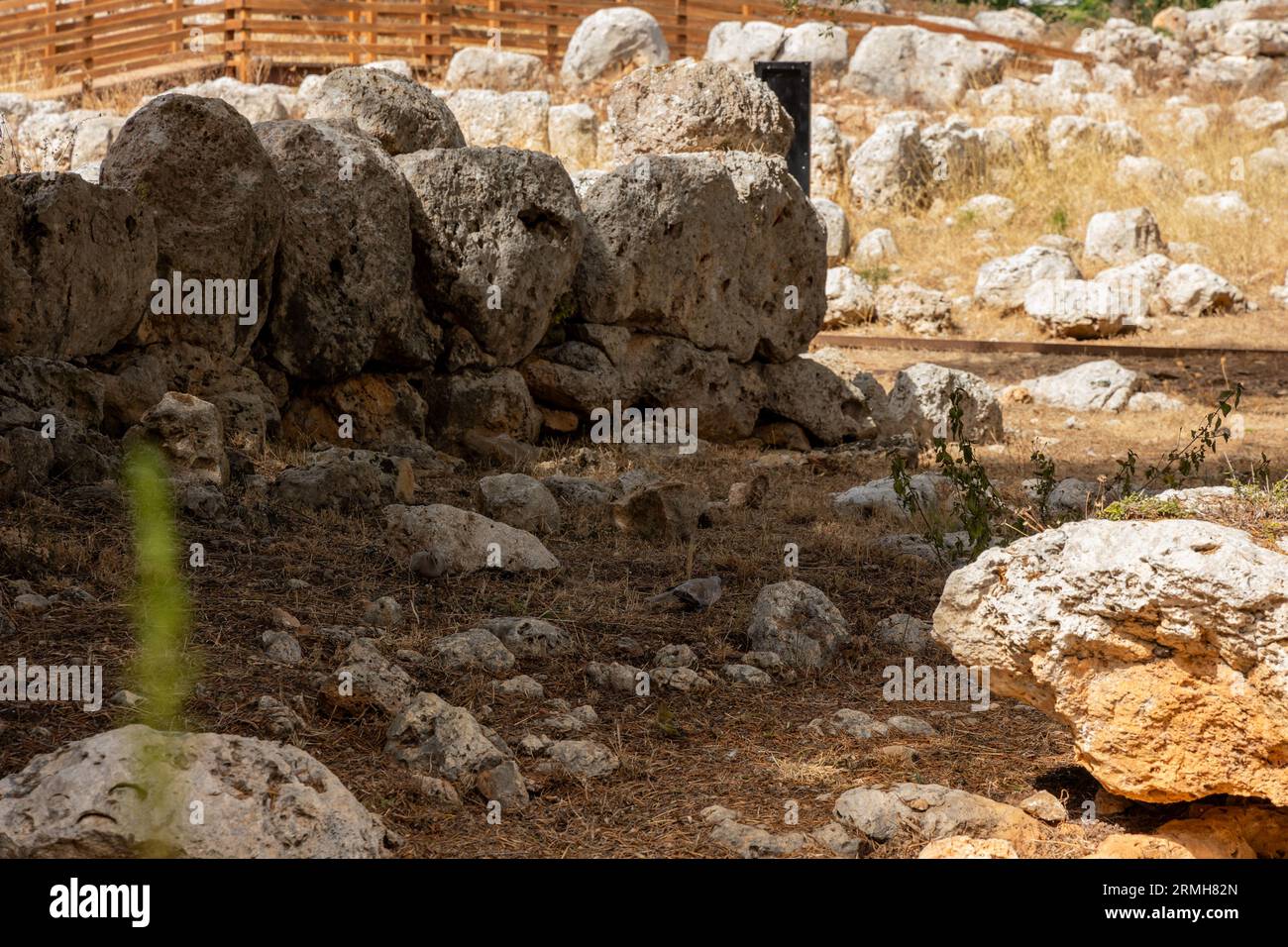 A stone wall at S'Illot's Talaiotic Settlement on a sunny day Stock Photo