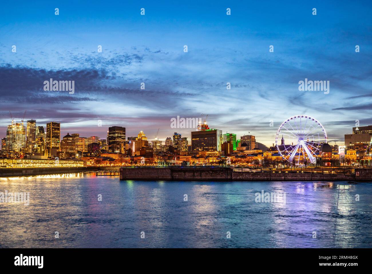 Montreal Canada city skyline at sunset with buildings and river in view. Stock Photo