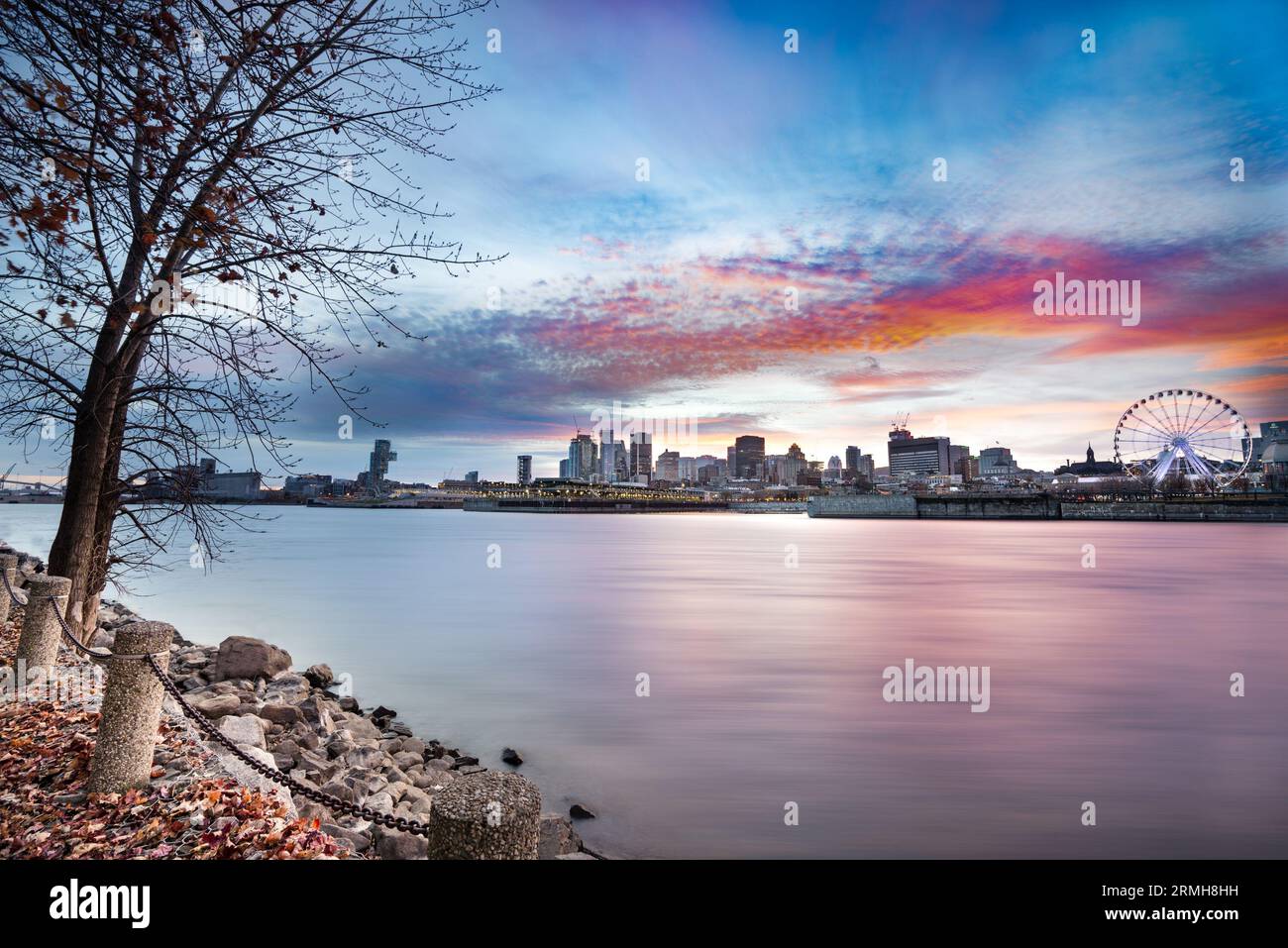 Montreal Canada city skyline at sunset with buildings and river in view. Stock Photo