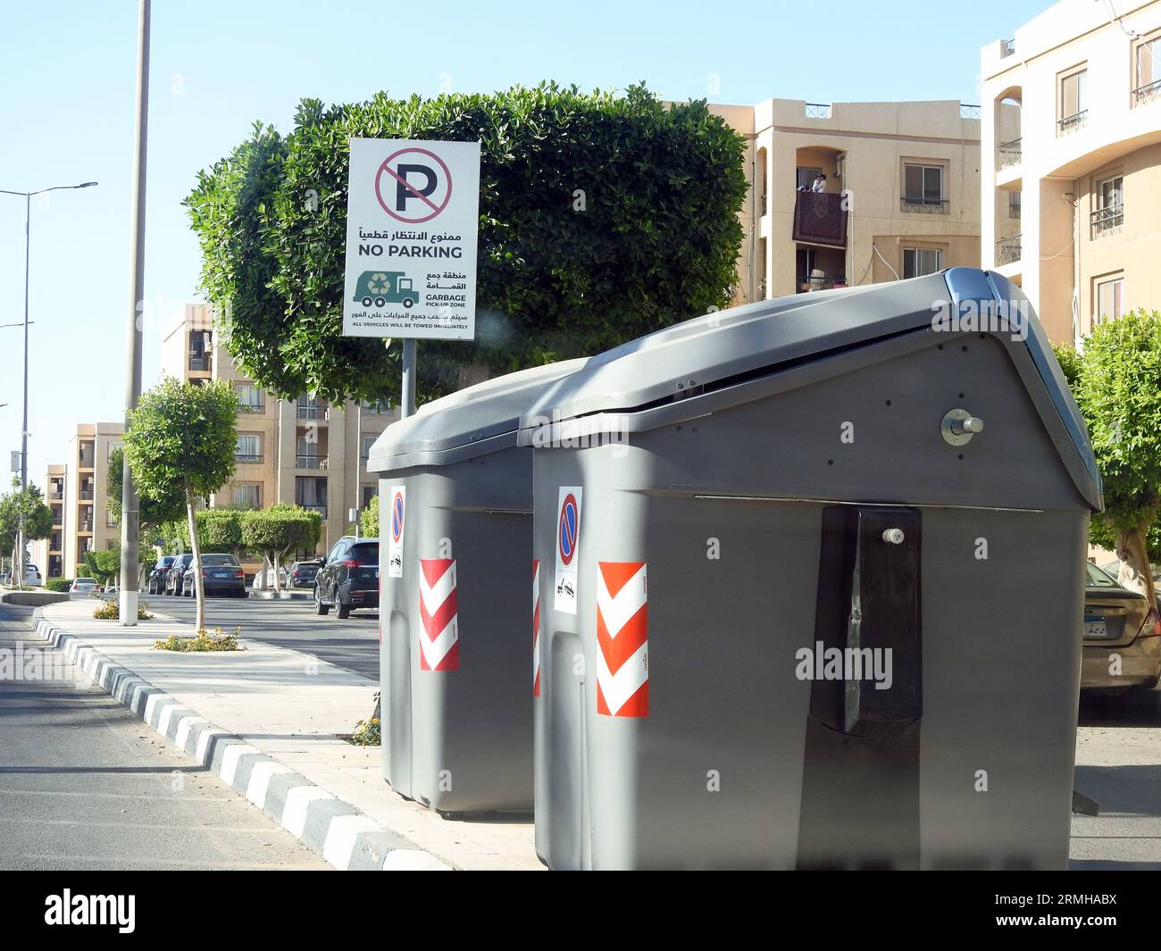 Cairo, Egypt, July 22 2023: Garbage pick up zone, litter boxes dumpster, rubbish barge area for the garbage vehicles to collect in this No Parking zon Stock Photo