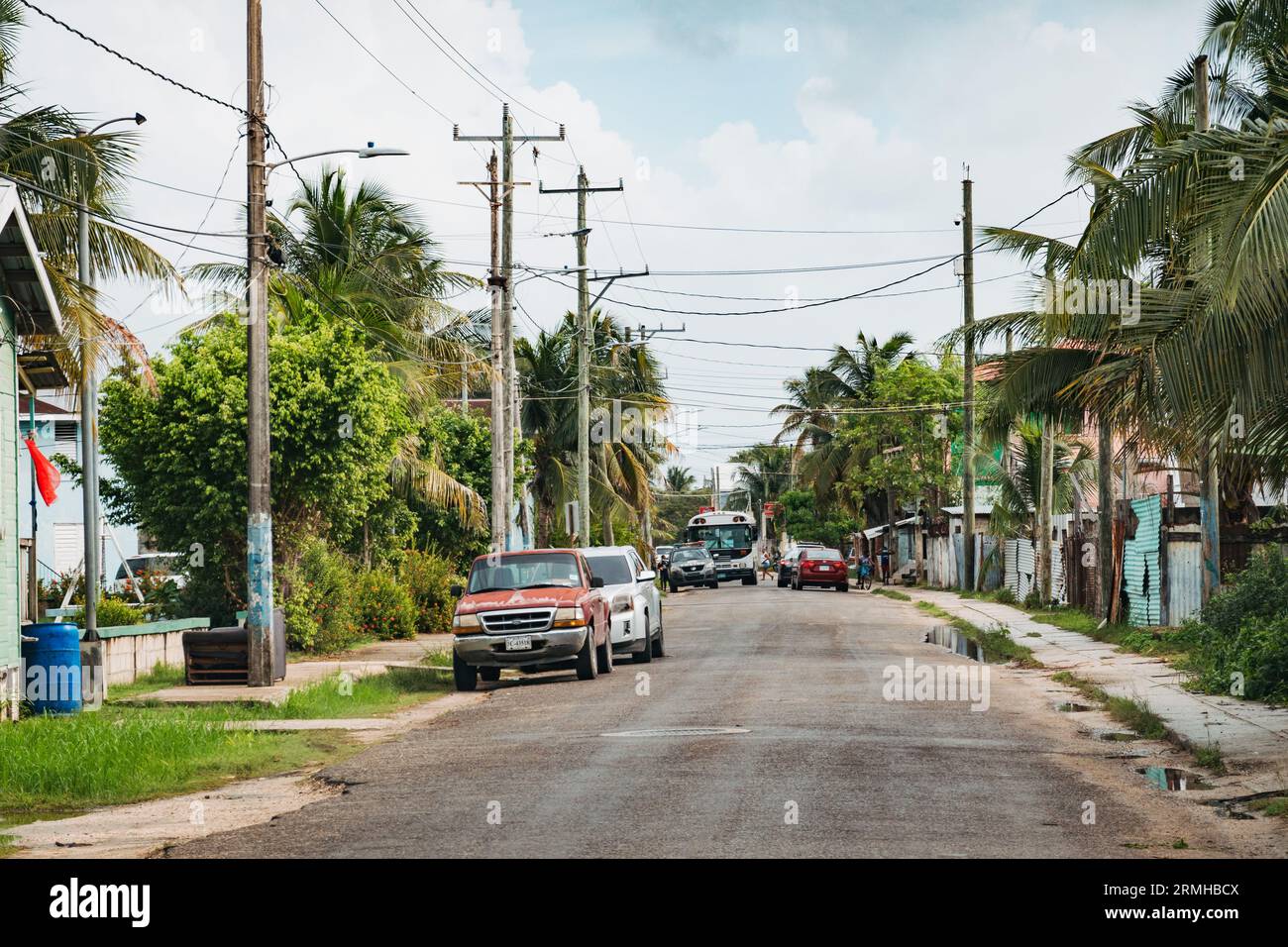 cars parked on a residential street in Belize City, Belize Stock Photo