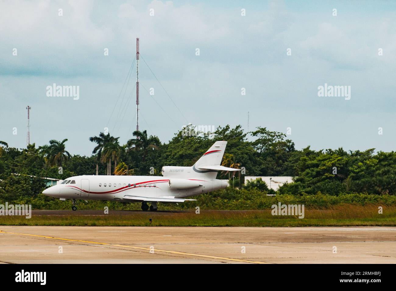 a Dassault Falcon 900 private jet taxis at Philip S.W. Goldson International Airport, Belize City, Belize Stock Photo