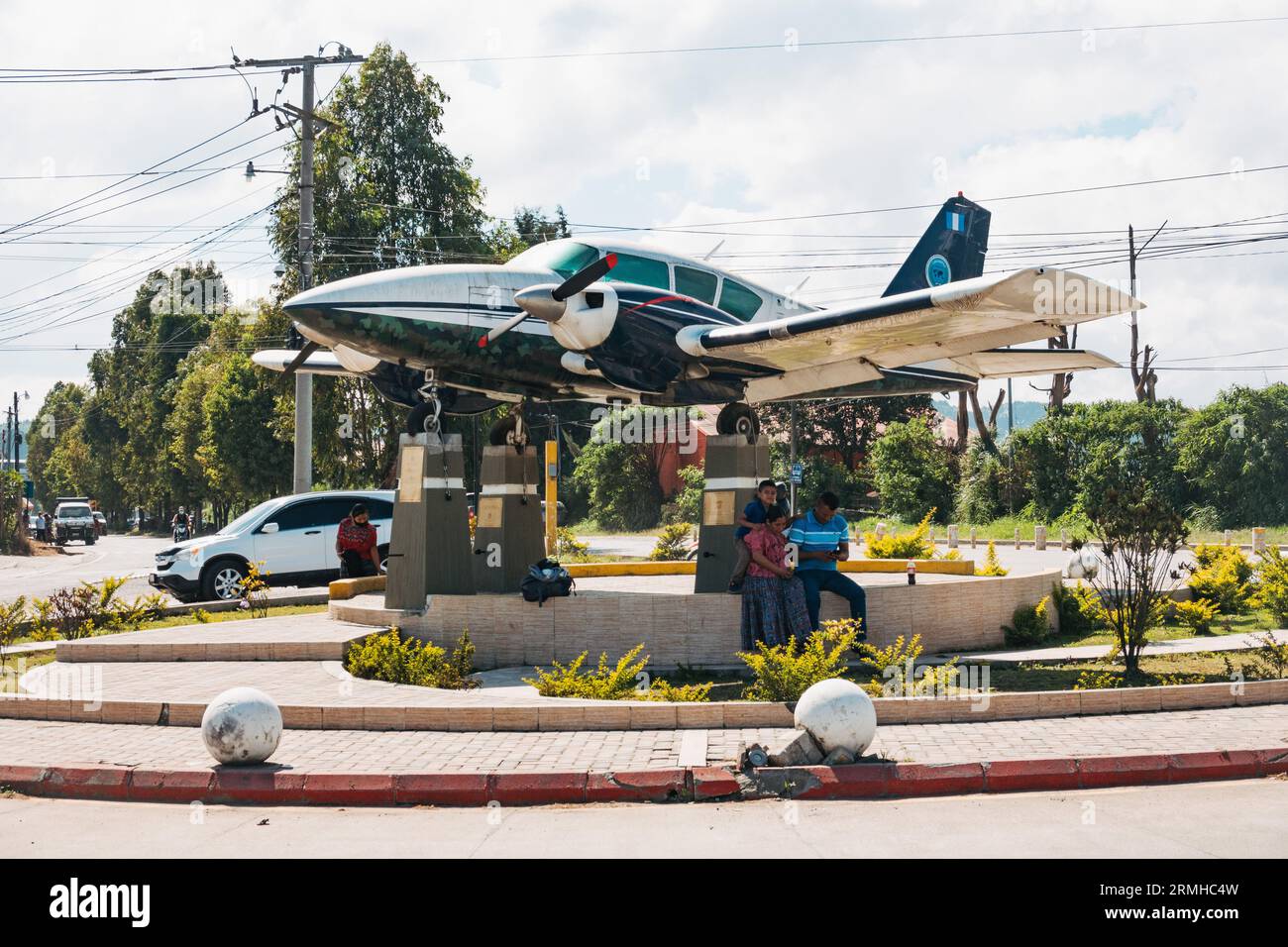 a Piper Aztec mounted on a traffic roundabout as a monument at the entrance to Cobán Airport, Guatemala Stock Photo