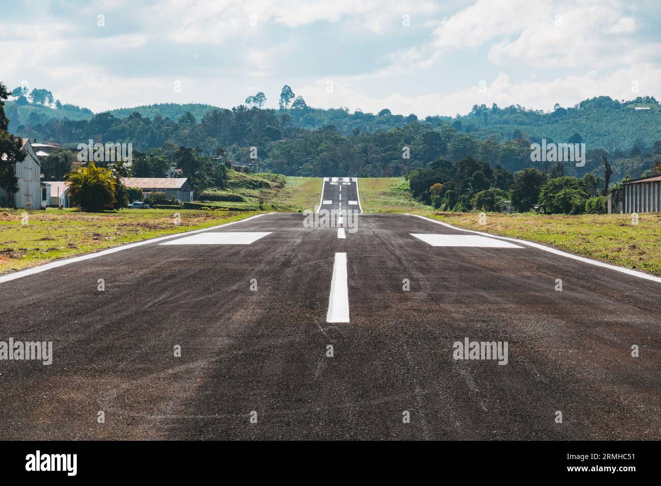 a short, inclined runway with new seal and paint at Cobán Airport, a small aerodrome with a 955 m runway in the Alta Verapaz region of Guatemala Stock Photo